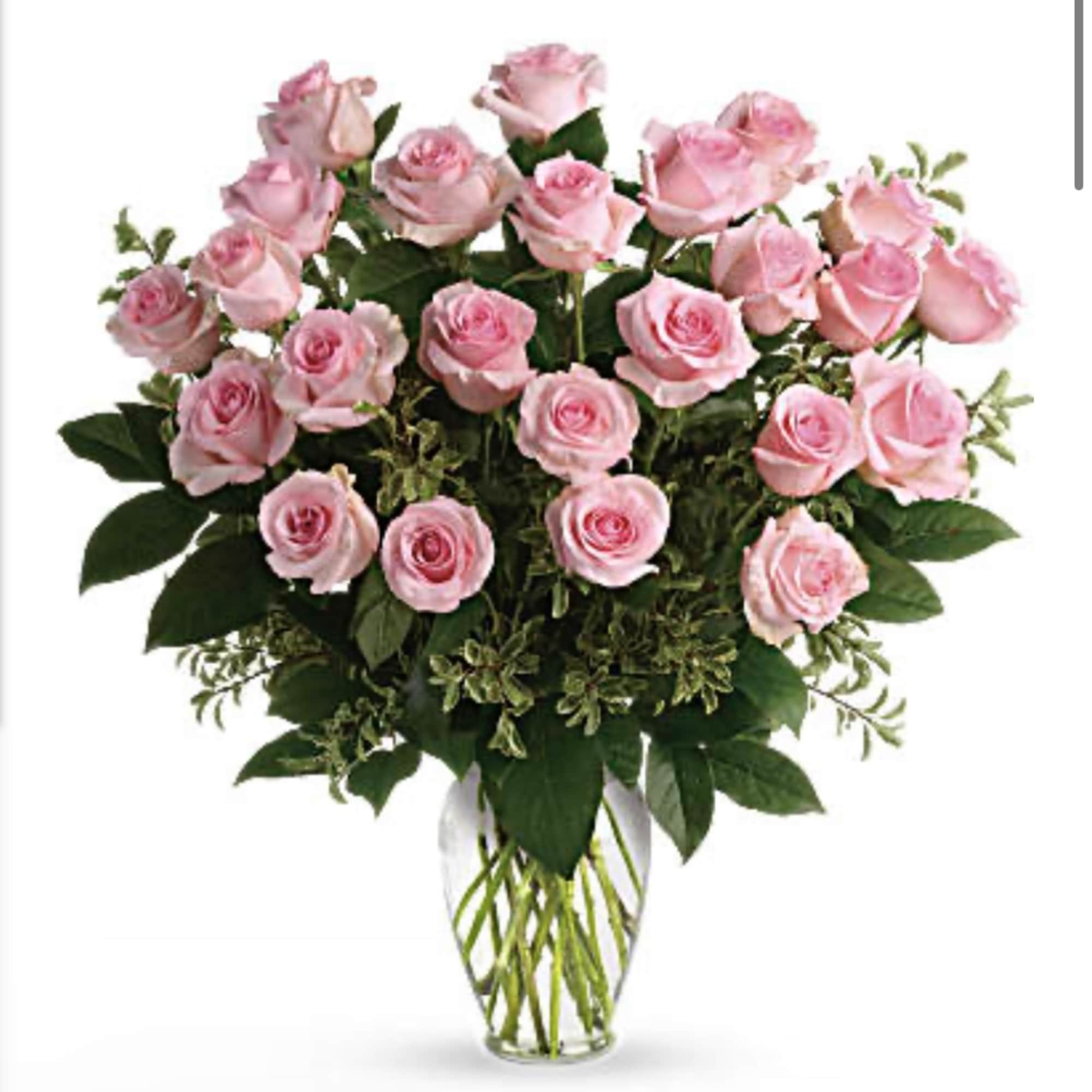 Pink roses arranged in a clear glass vase