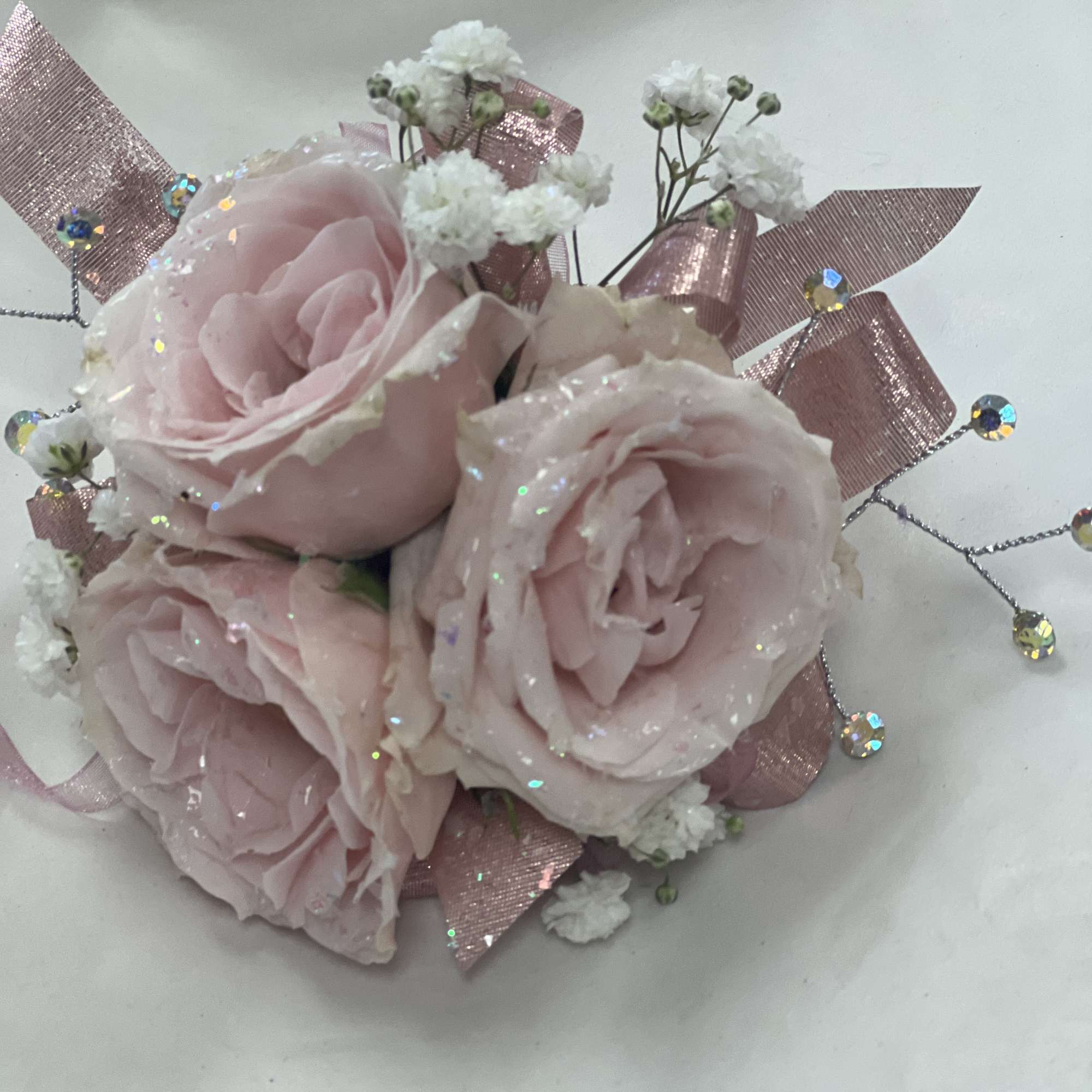 Soft roses dusted with iridescent glitter create a romantic prom corsage that, photo 2 of 3