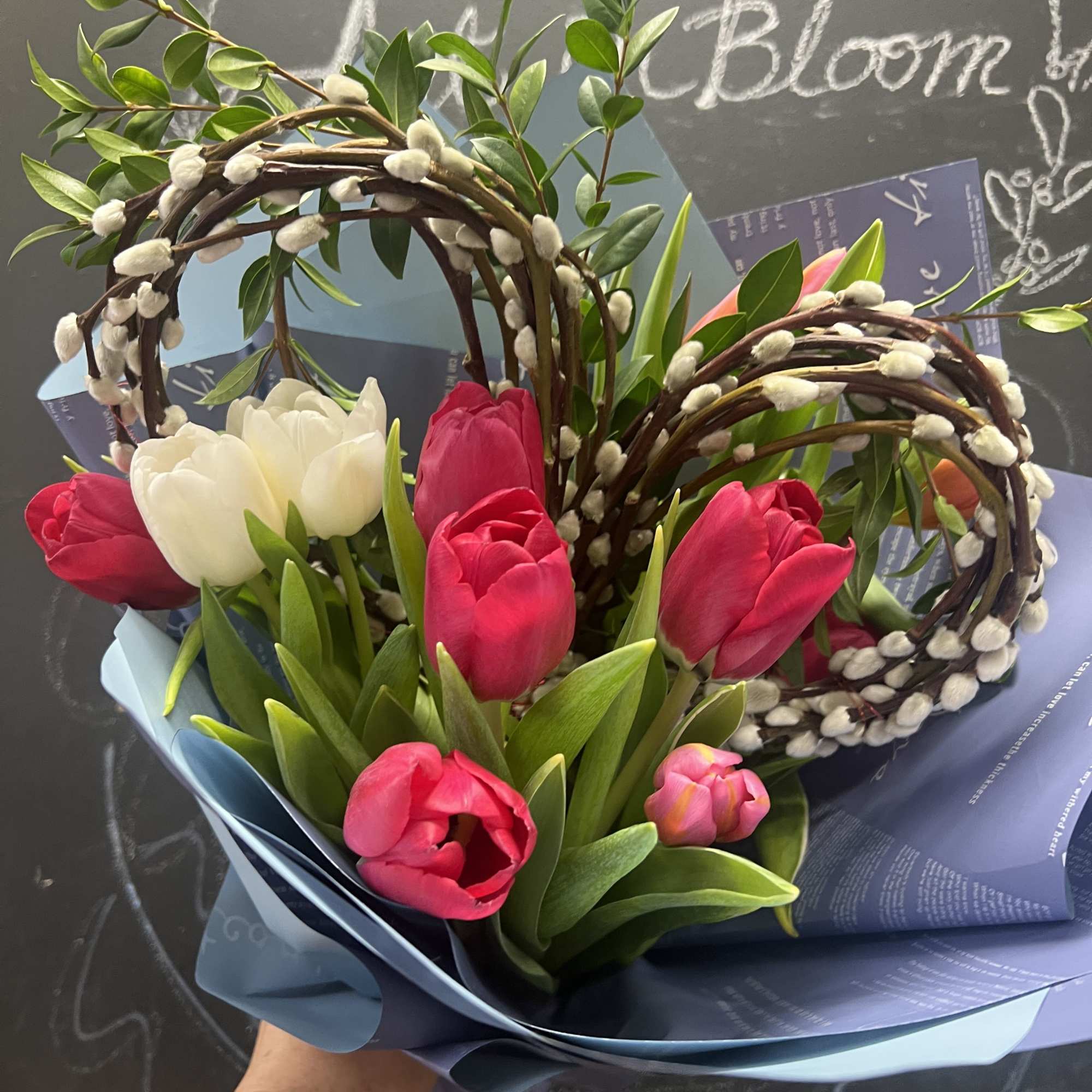 Bouquet of pink and white tulips with curly willow and pussy willow branches