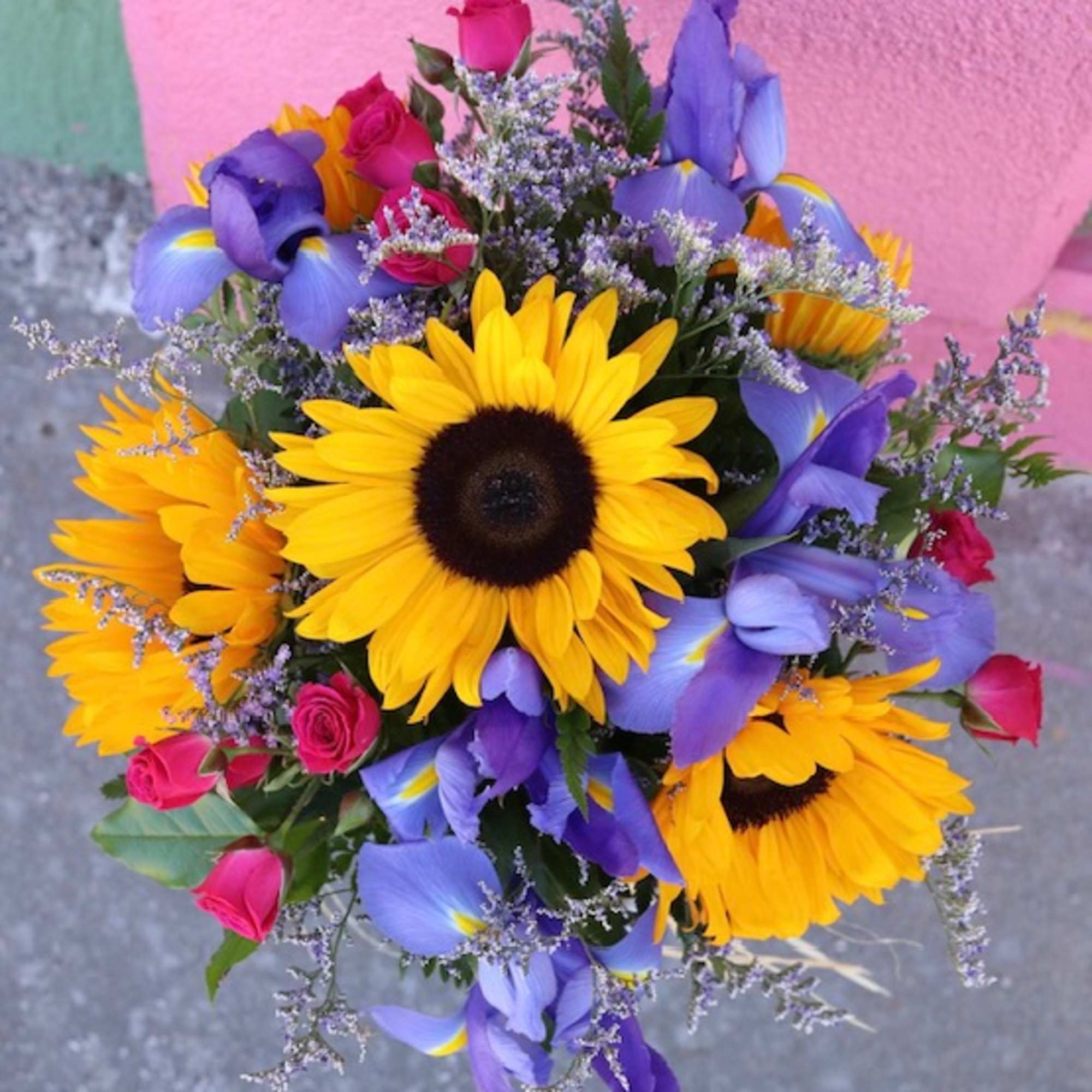Bouquet of sunflowers, purple irises, and pink roses