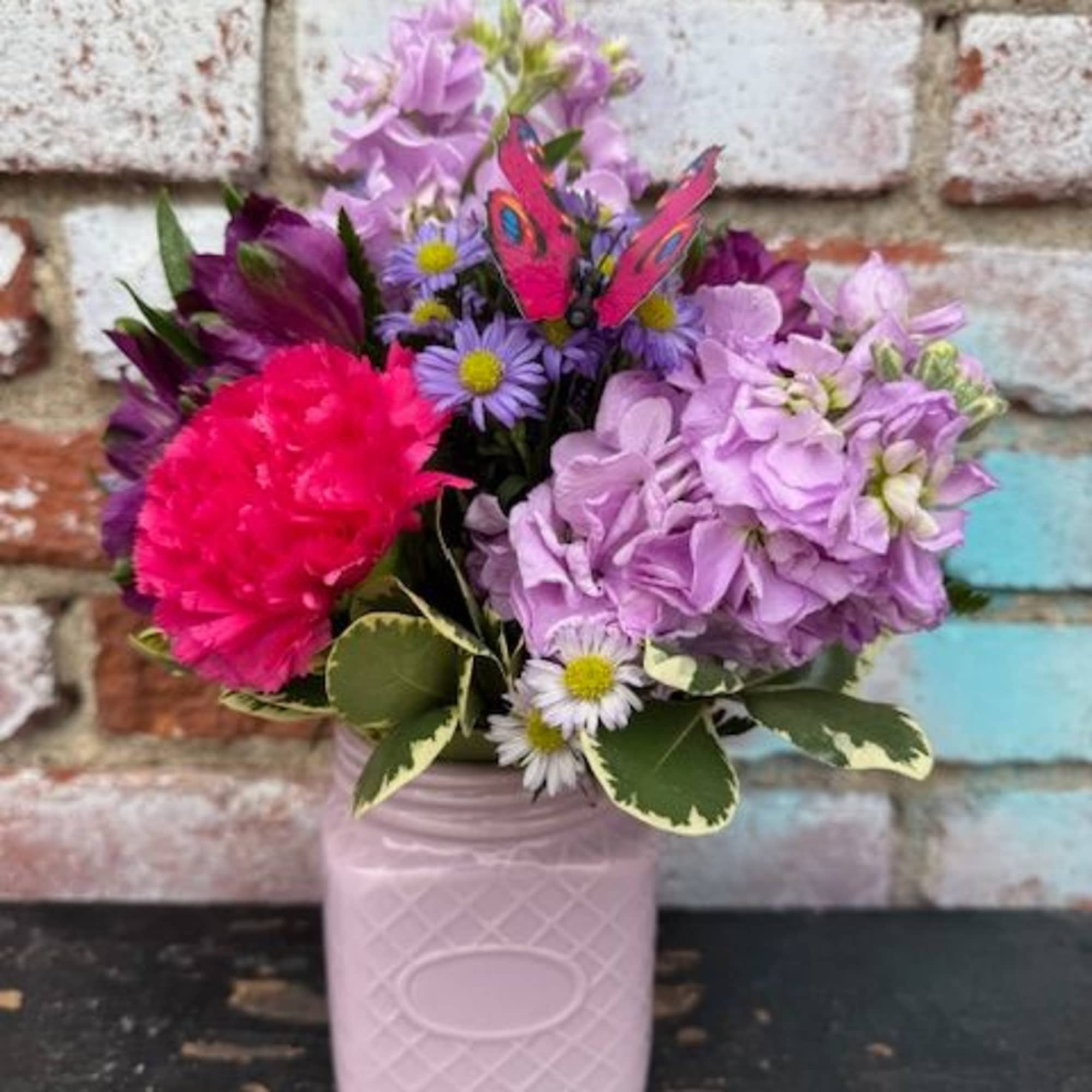 Pink and lavender bouquet in a pale pink vase