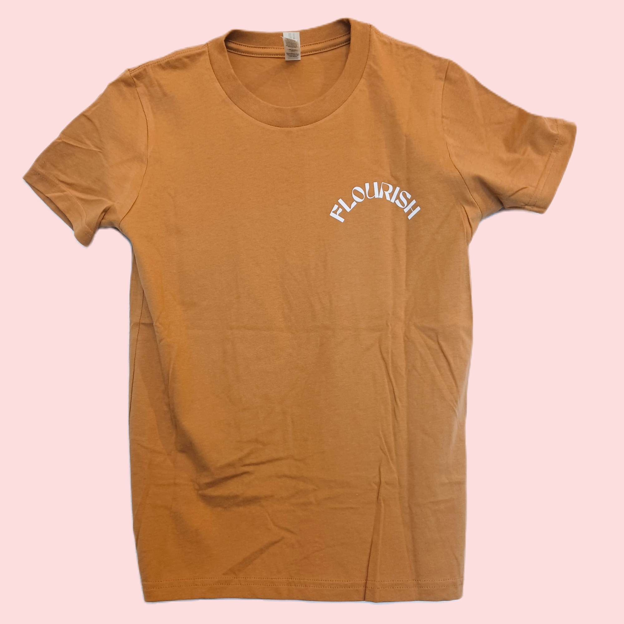 Tan T-shirt with "FLOURISH" printed on the chest