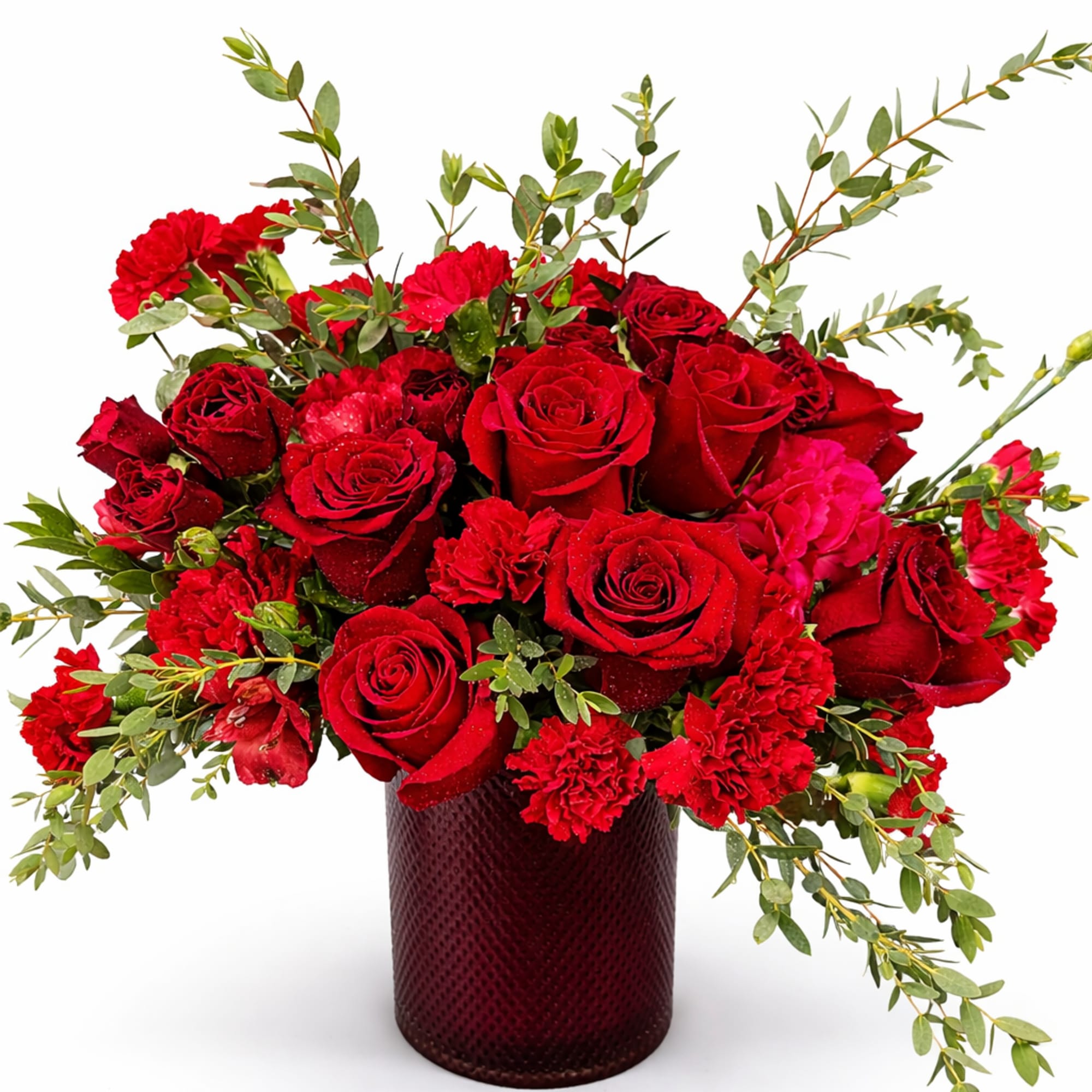 Red roses and carnations in a dark glass vase