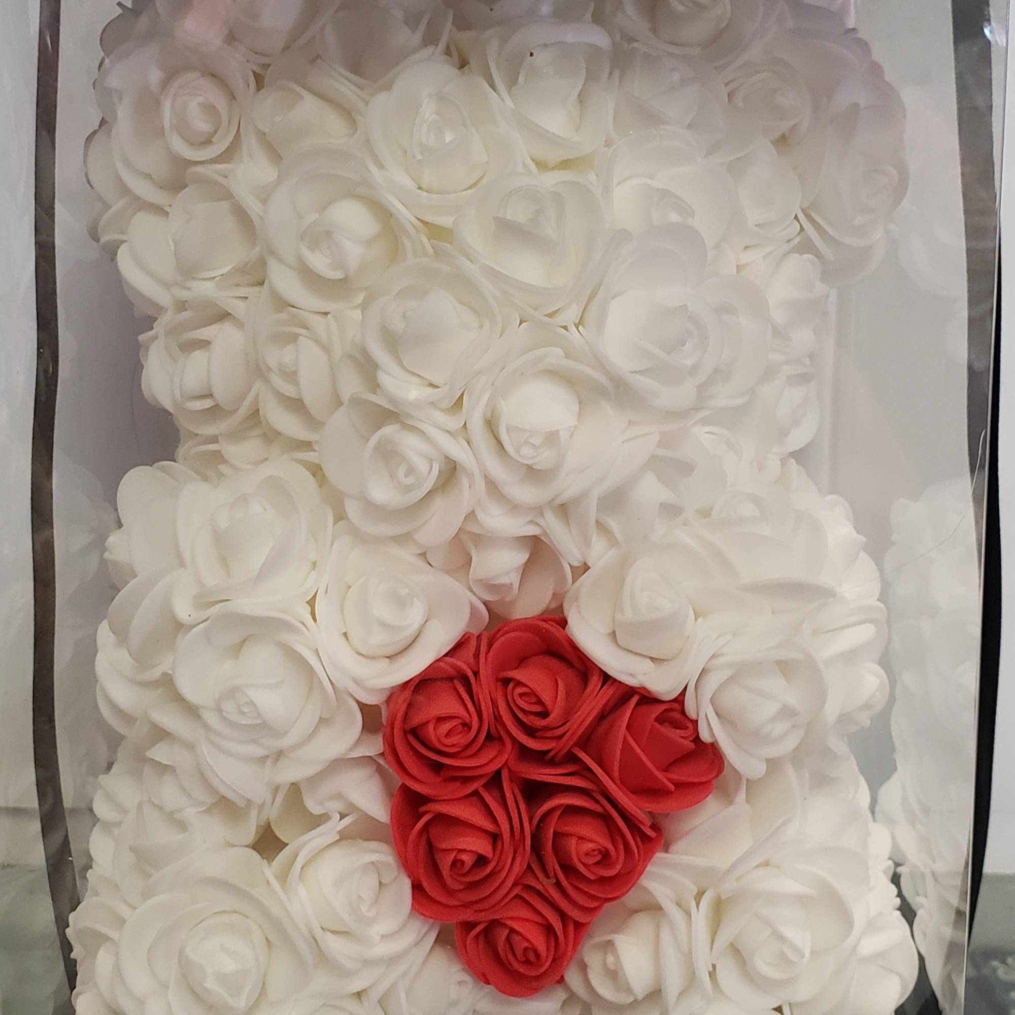 White rose teddy bear with a red heart on its chest