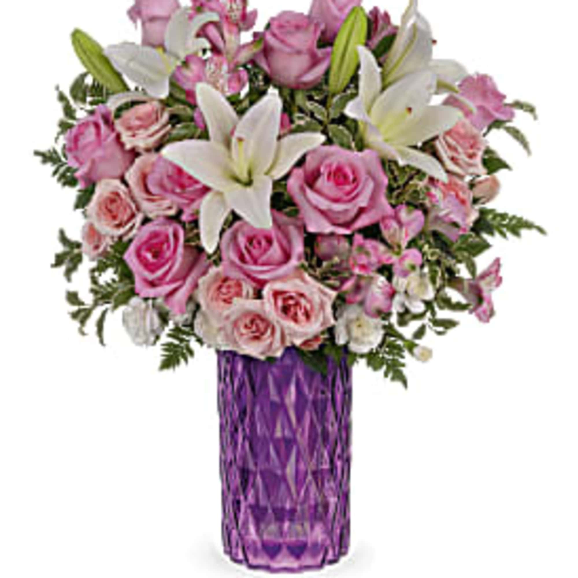 Pink roses and white lilies in a purple glass vase