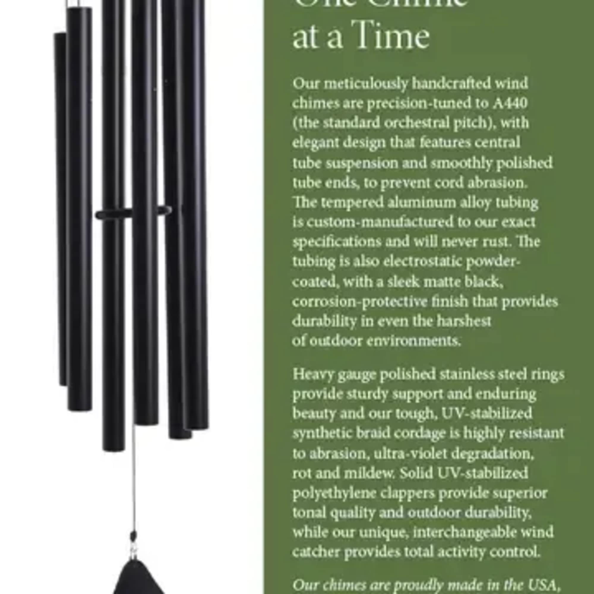Black metal wind chimes hanging beside a green text panel