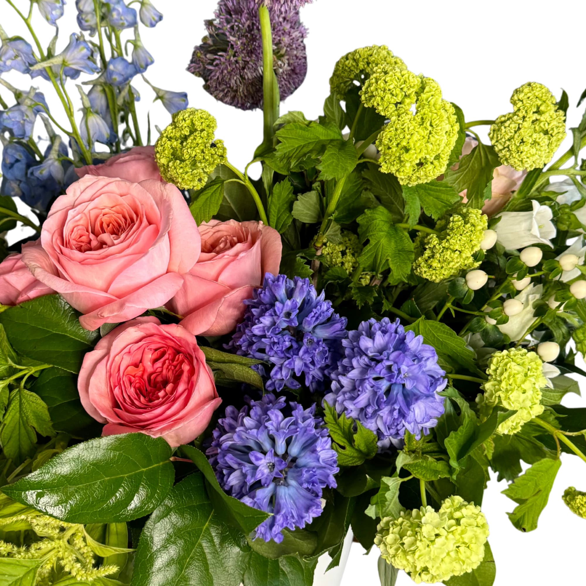 Bouquet of pink roses, blue flowers, and green blooms