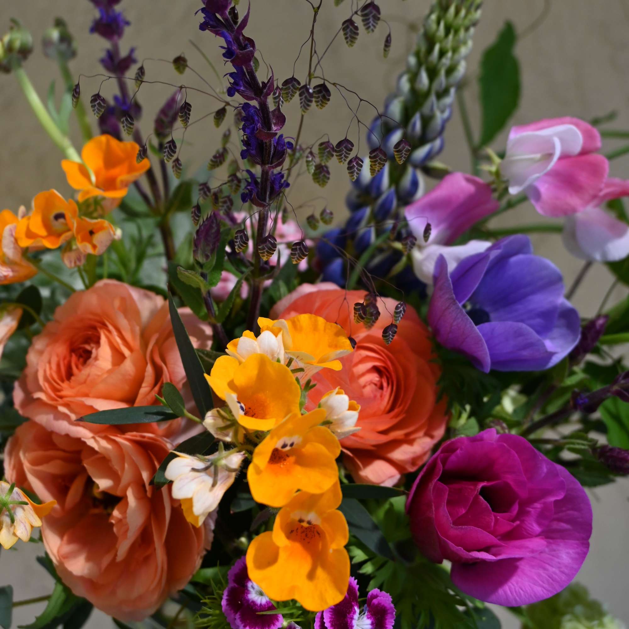 Colorful mixed bouquet with orange, purple, pink, and yellow flowers