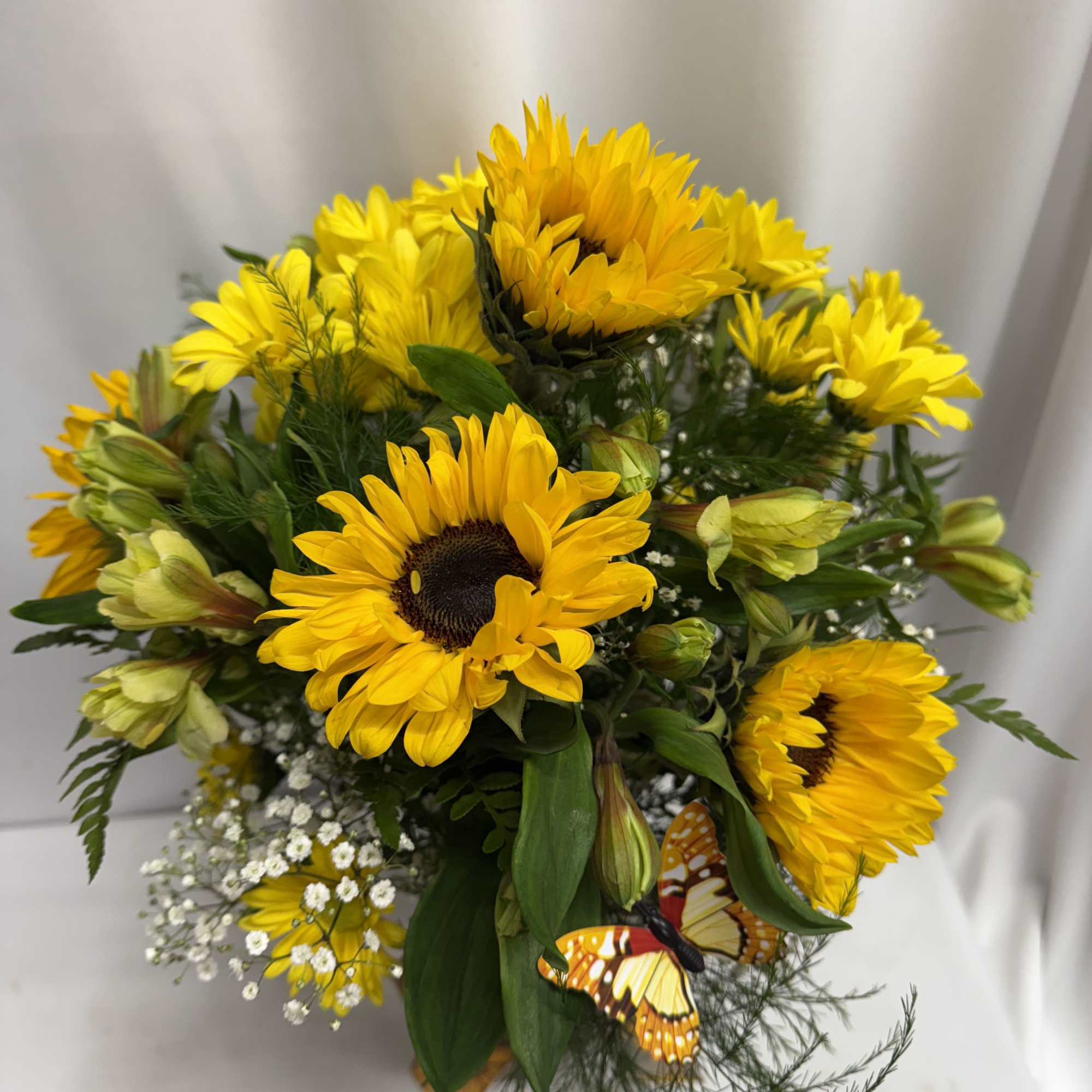 Bouquet of yellow sunflowers with small white filler flowers