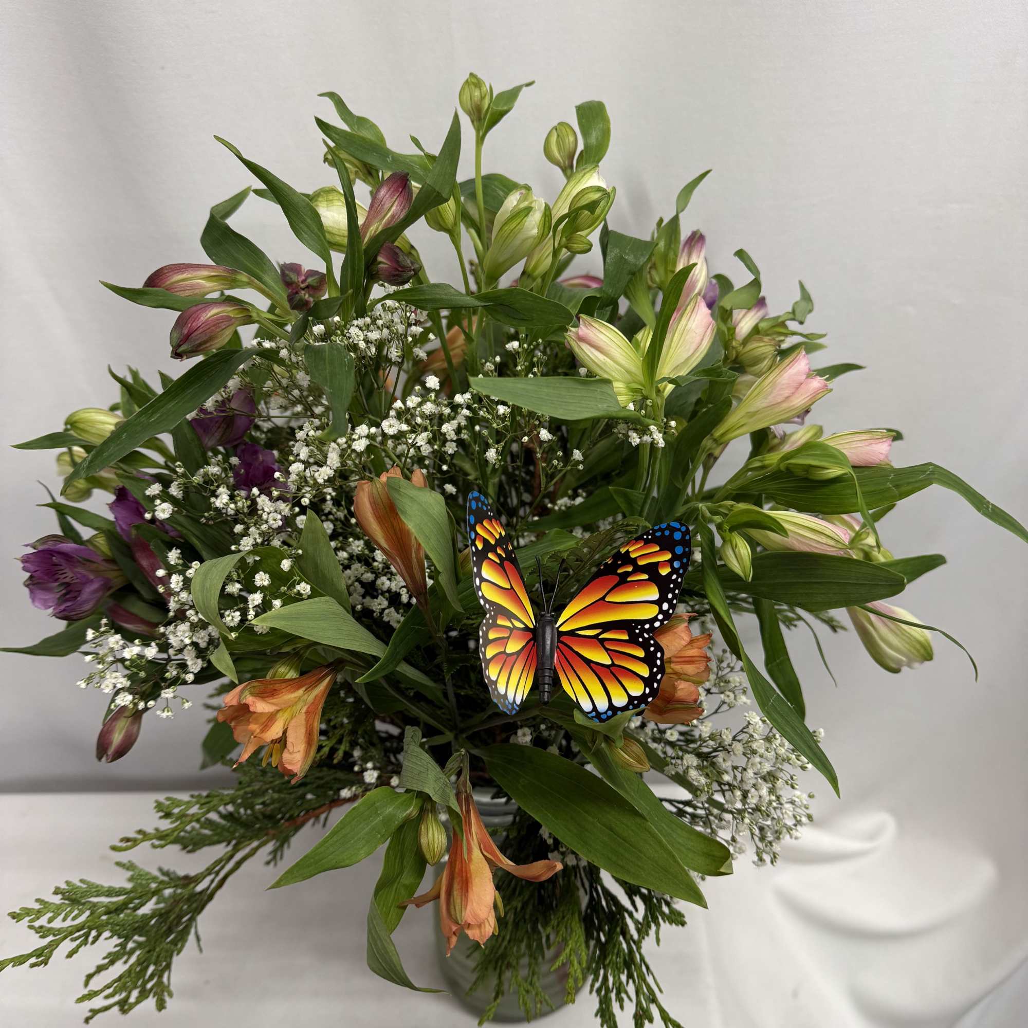 Mixed bouquet with alstroemeria, baby's breath, and a butterfly decoration