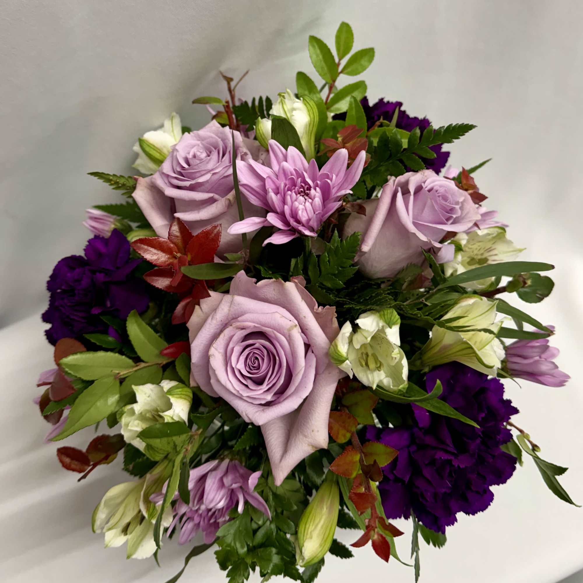 Lavender roses and purple flowers in a mixed bouquet