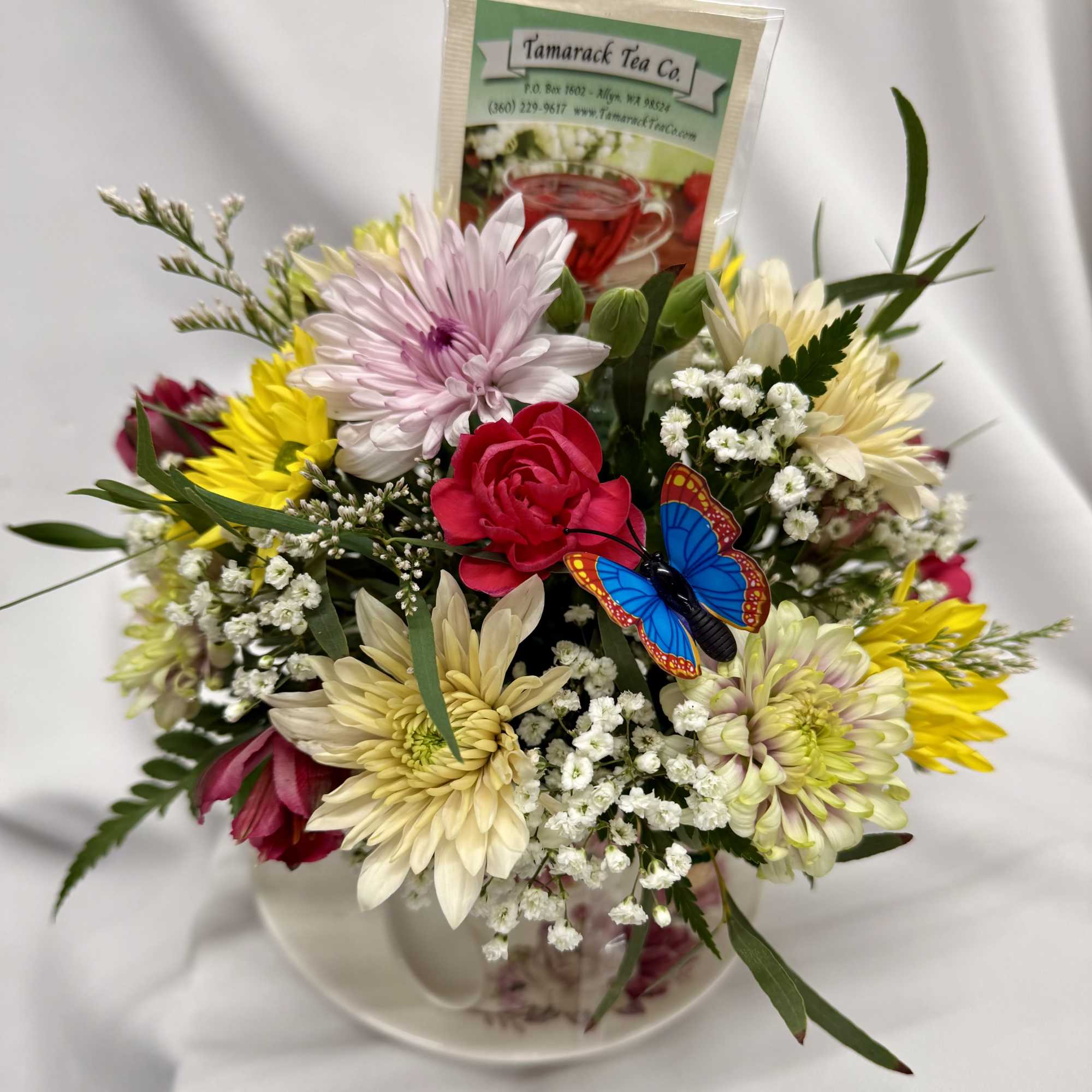 A cozy cluster of mixed roses, daisies, alstroemeria and chrysanthemums arranged in