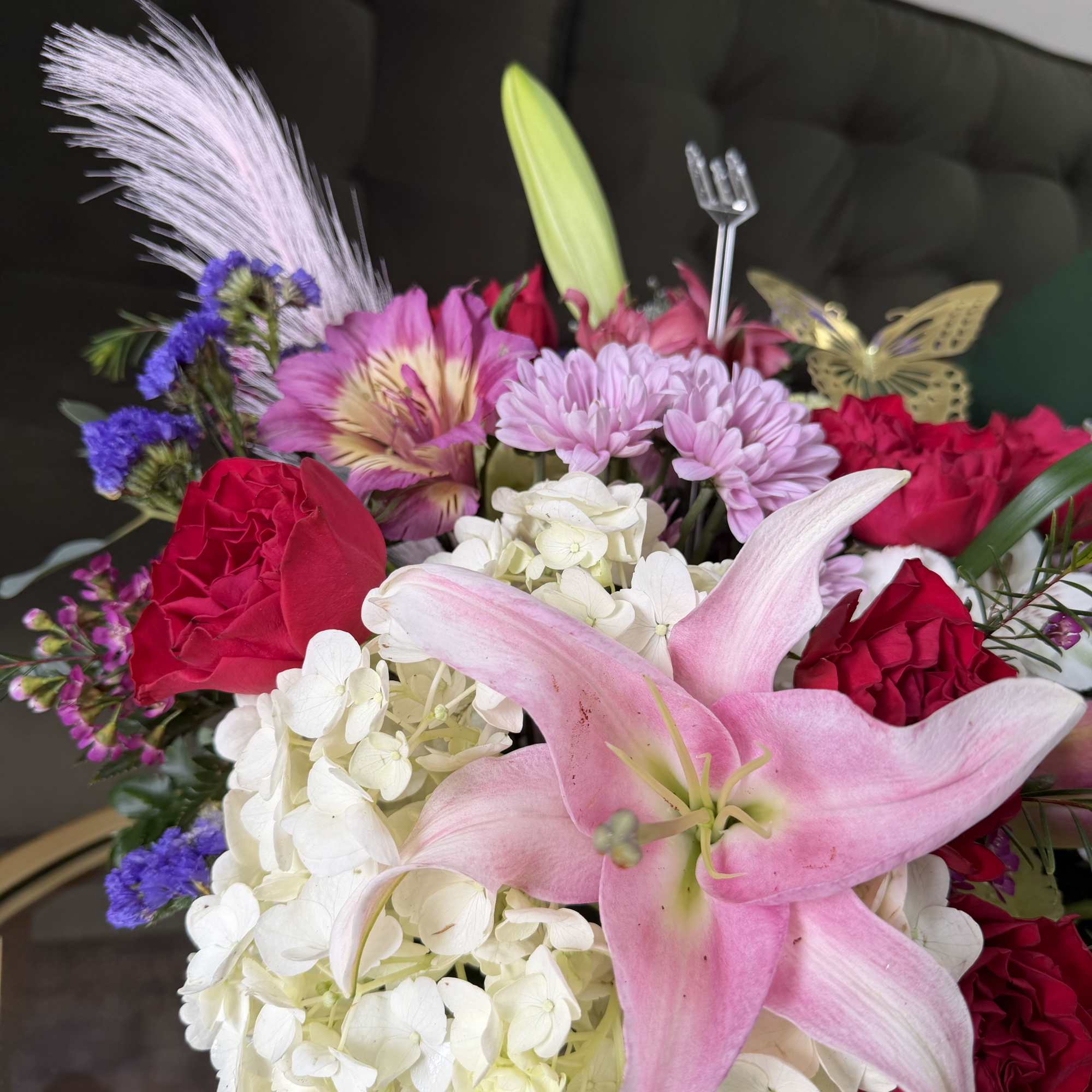 Bright pink roses and stargazer lilies come together with purple lisianthus and