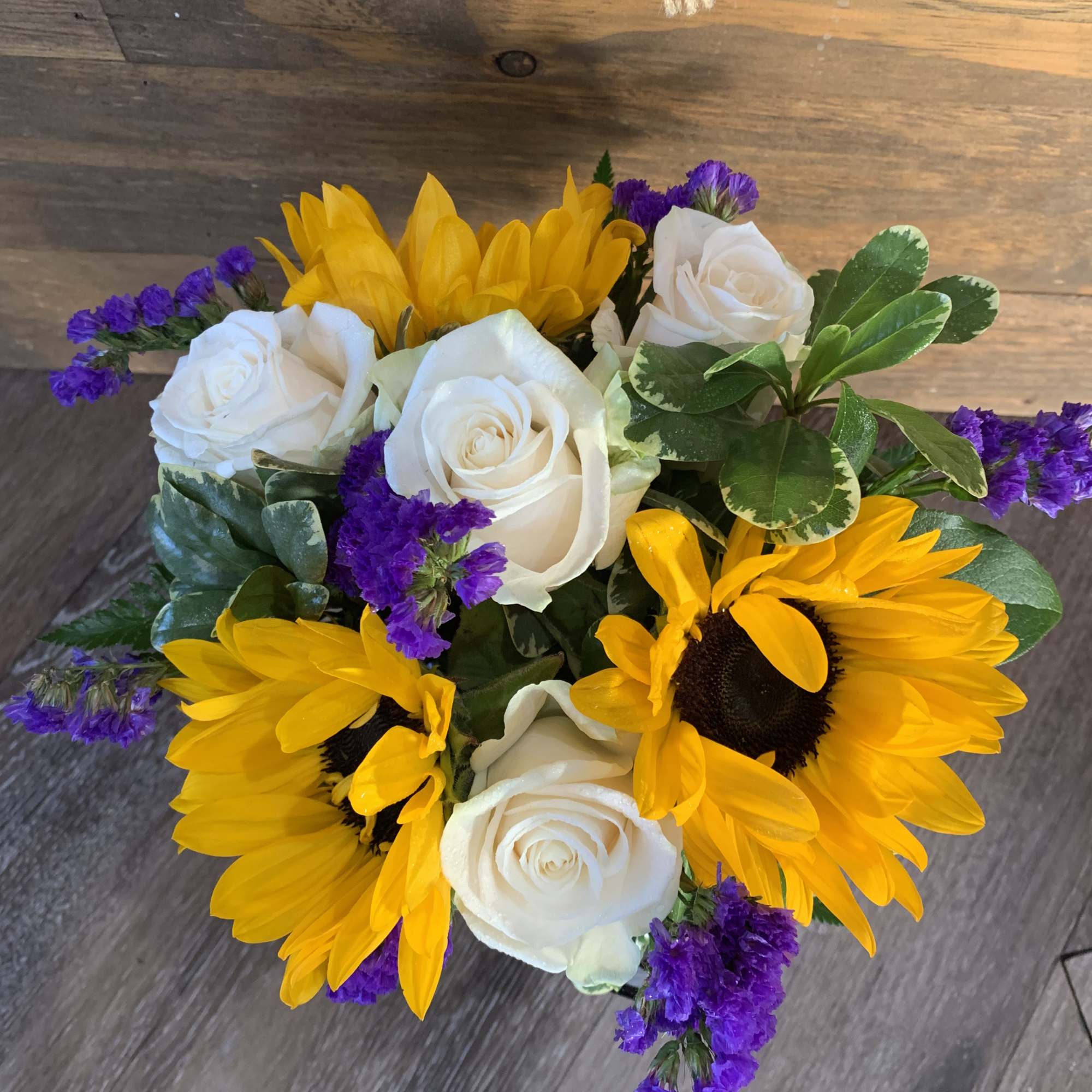 Mason jar filled with sunflowers and roses, photo 2 of 2