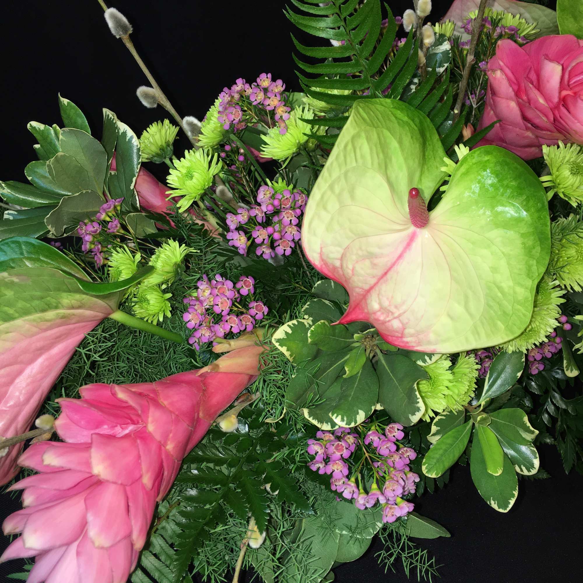 Pink anthuriums with green chrysanthemums and purple filler flowers