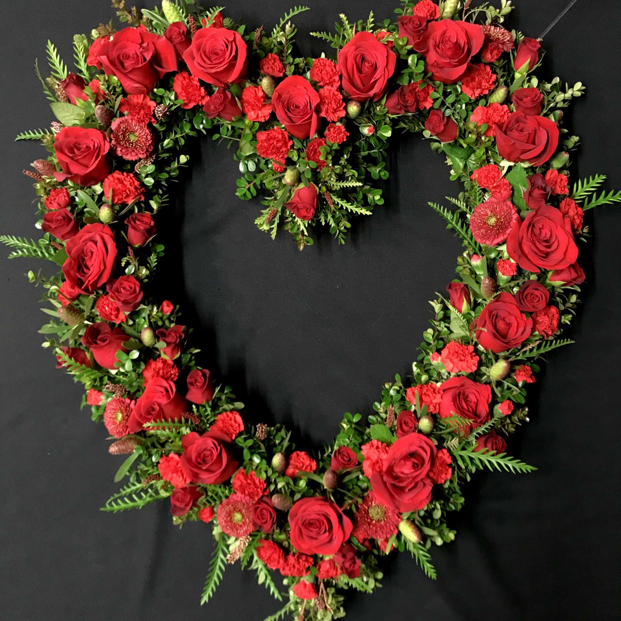 Assorted red sweet flowers for your loved one's wreath. Flower types will
