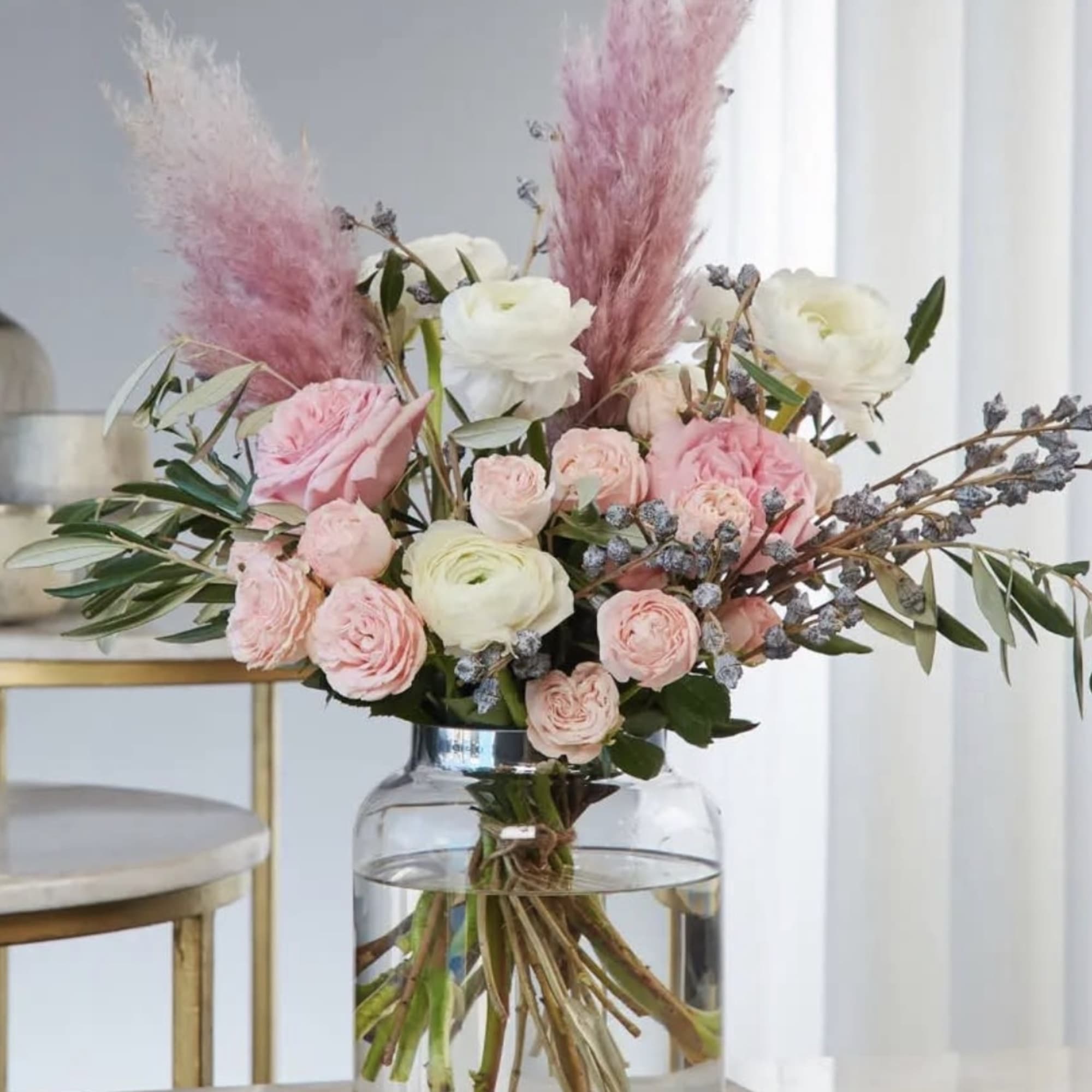 Pink and white floral arrangement in a clear glass vase