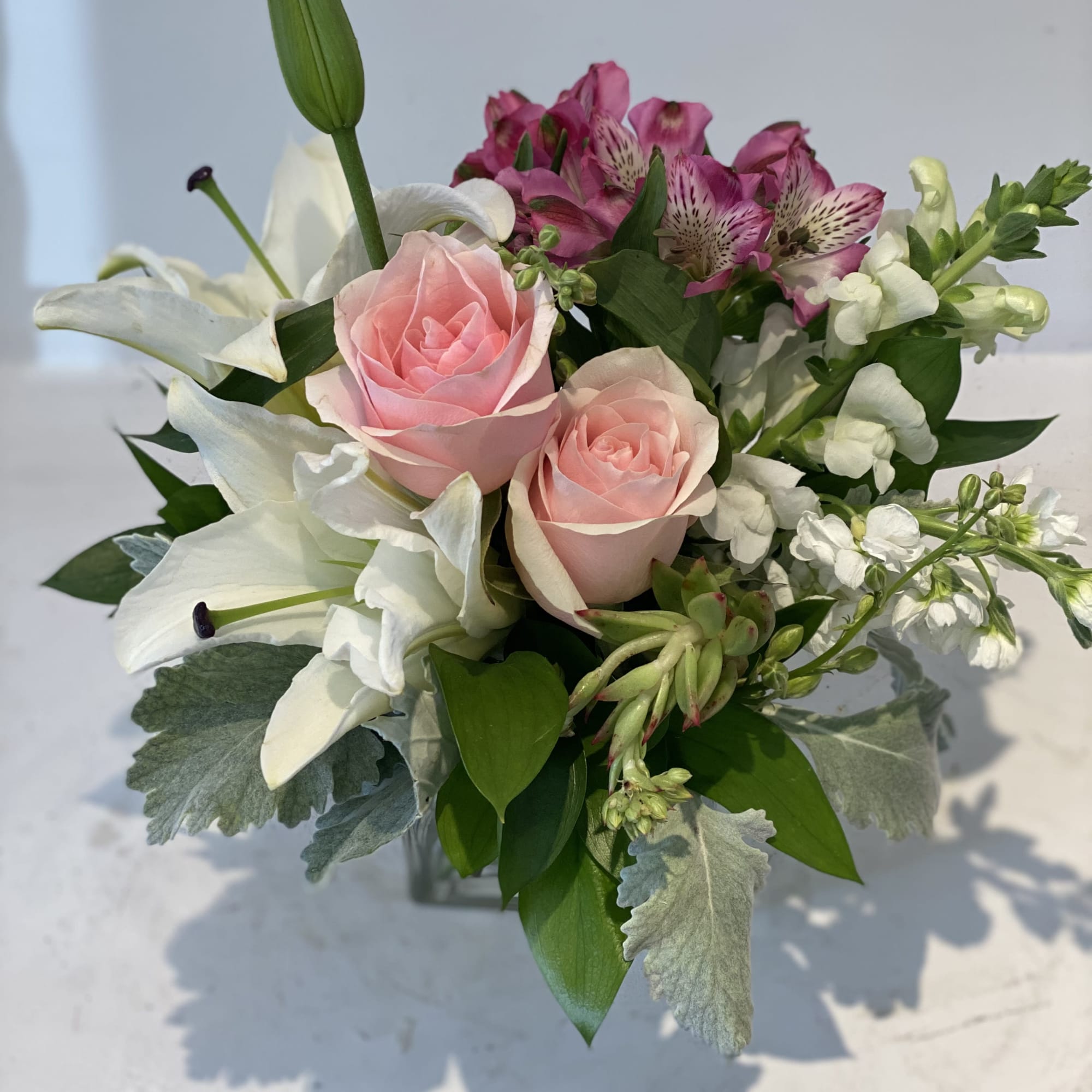 Bouquet of pink roses, white lilies, and magenta alstroemeria