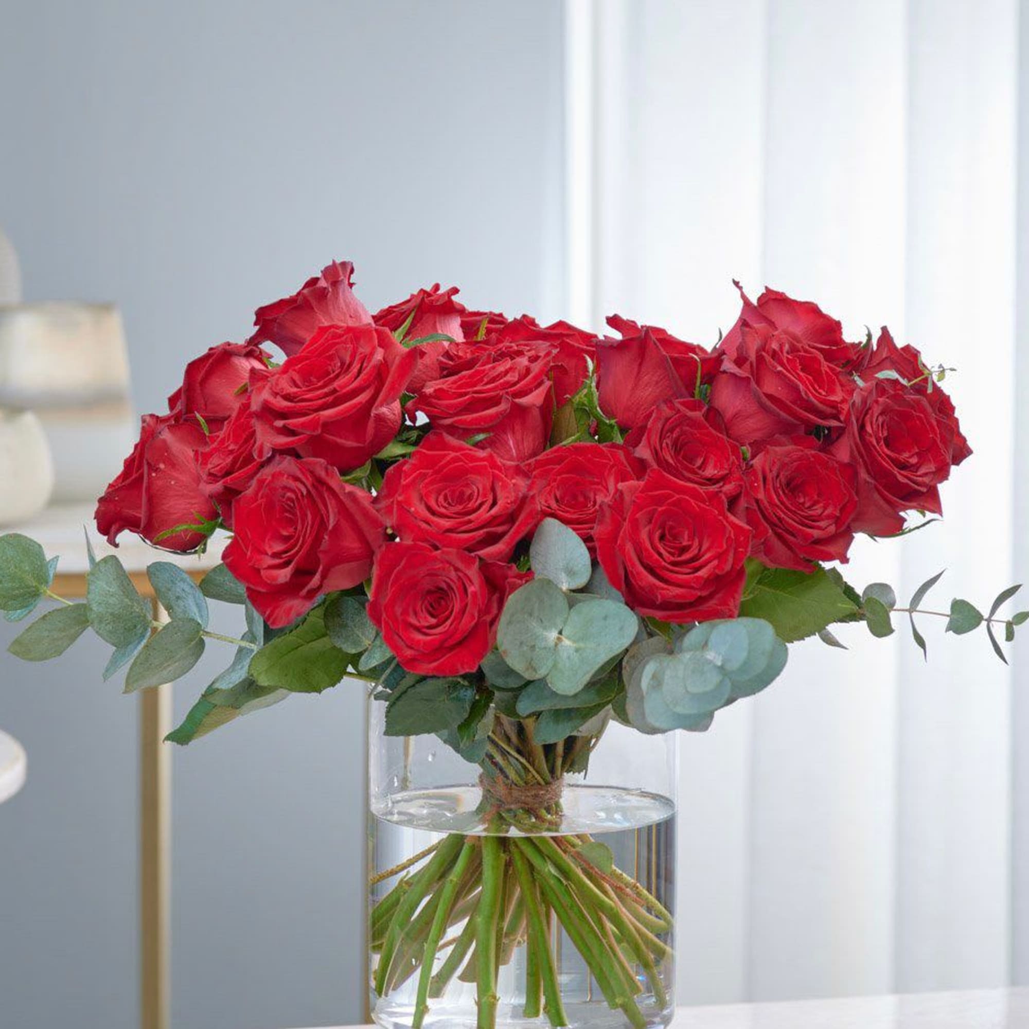 Bouquet of red roses in a clear glass vase