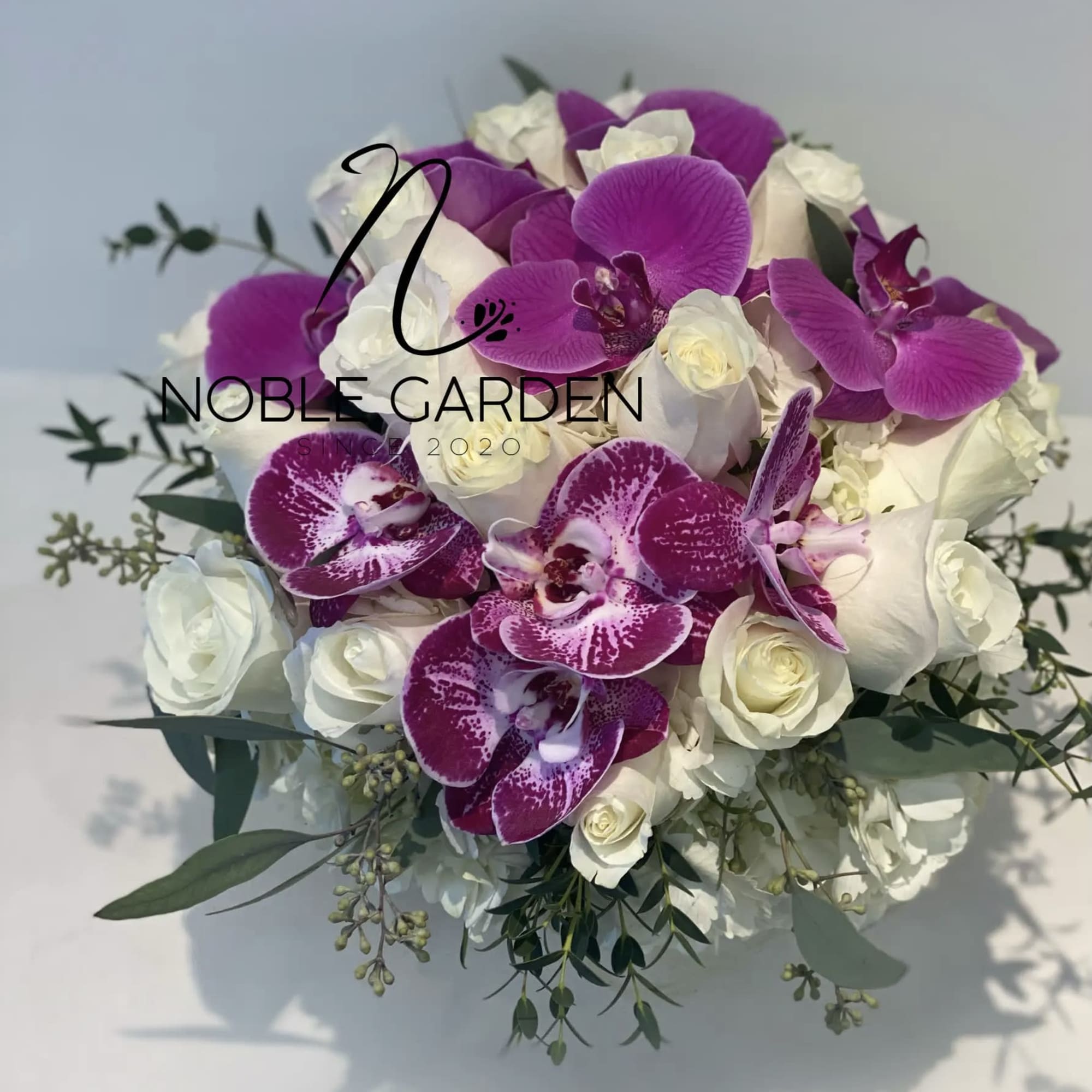 Bouquet of white roses and purple orchids