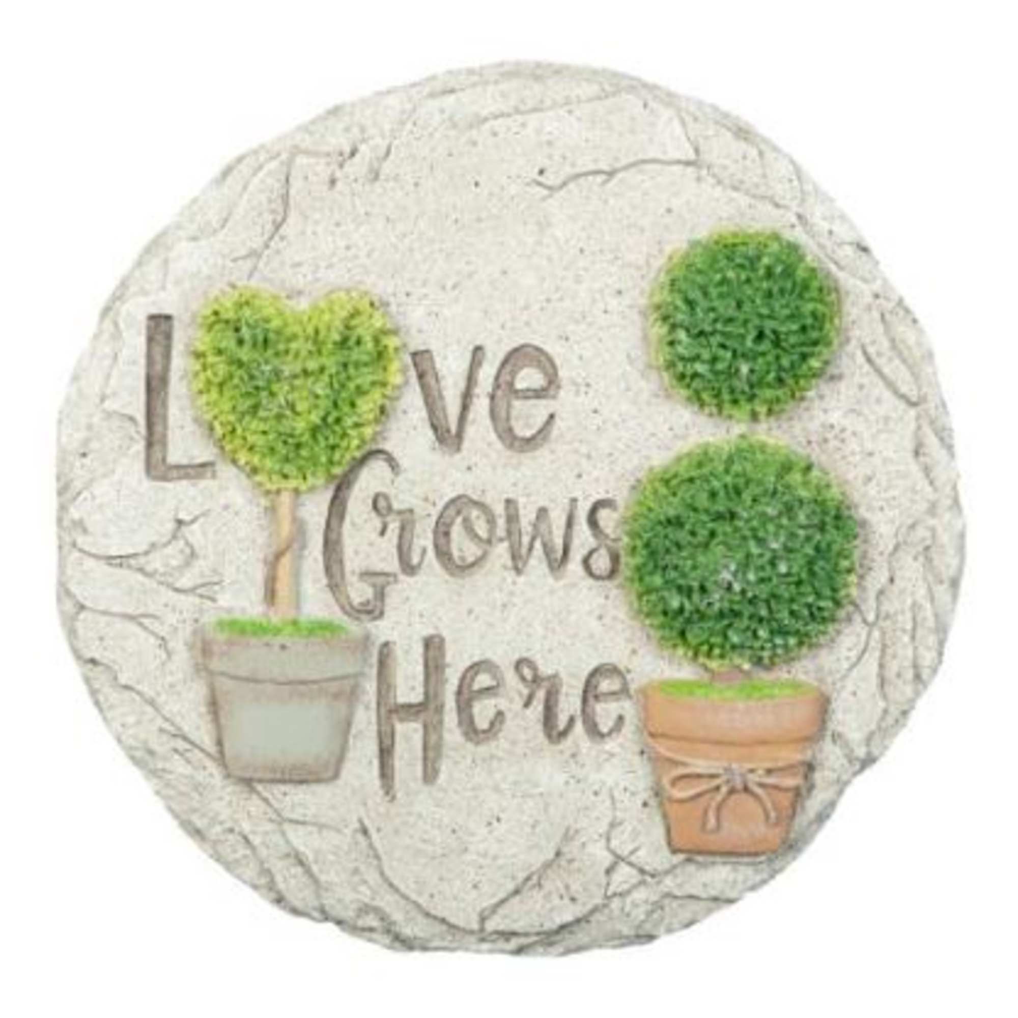 Round decorative plaque with the words "Love Grows Here" and potted topiary trees