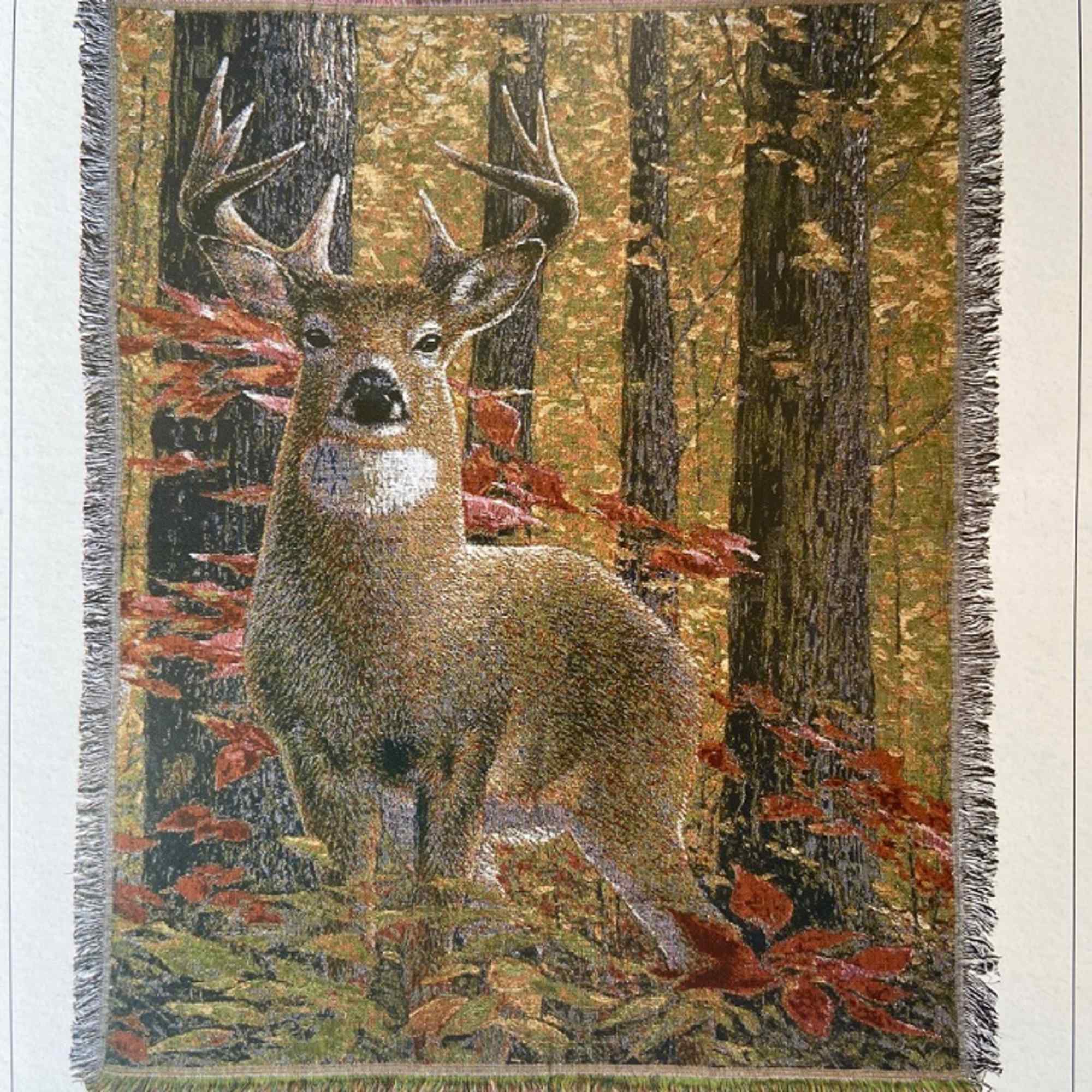 Fringed wall hanging with a deer in an autumn forest scene