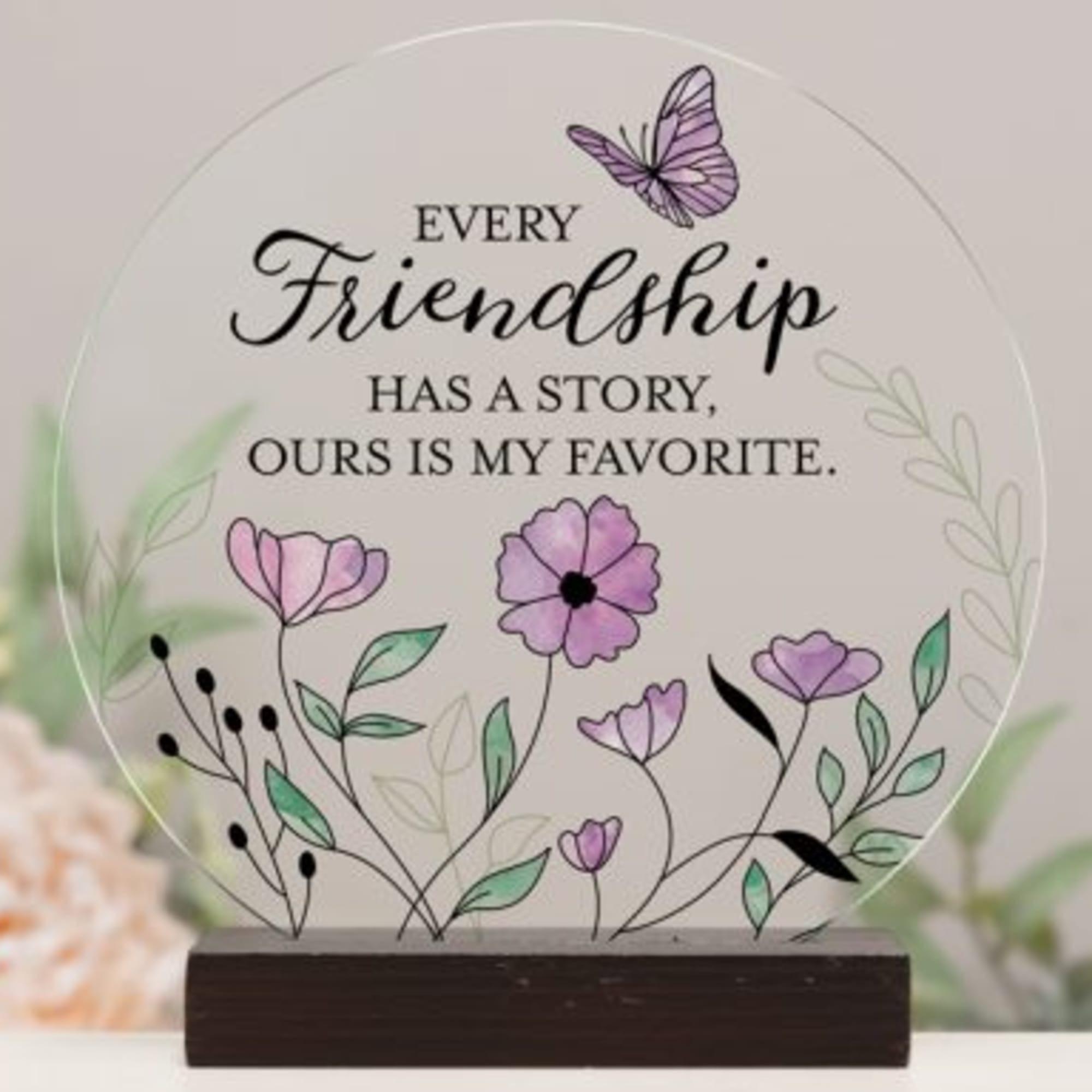 Round friendship plaque with purple flowers and a butterfly on a wooden base