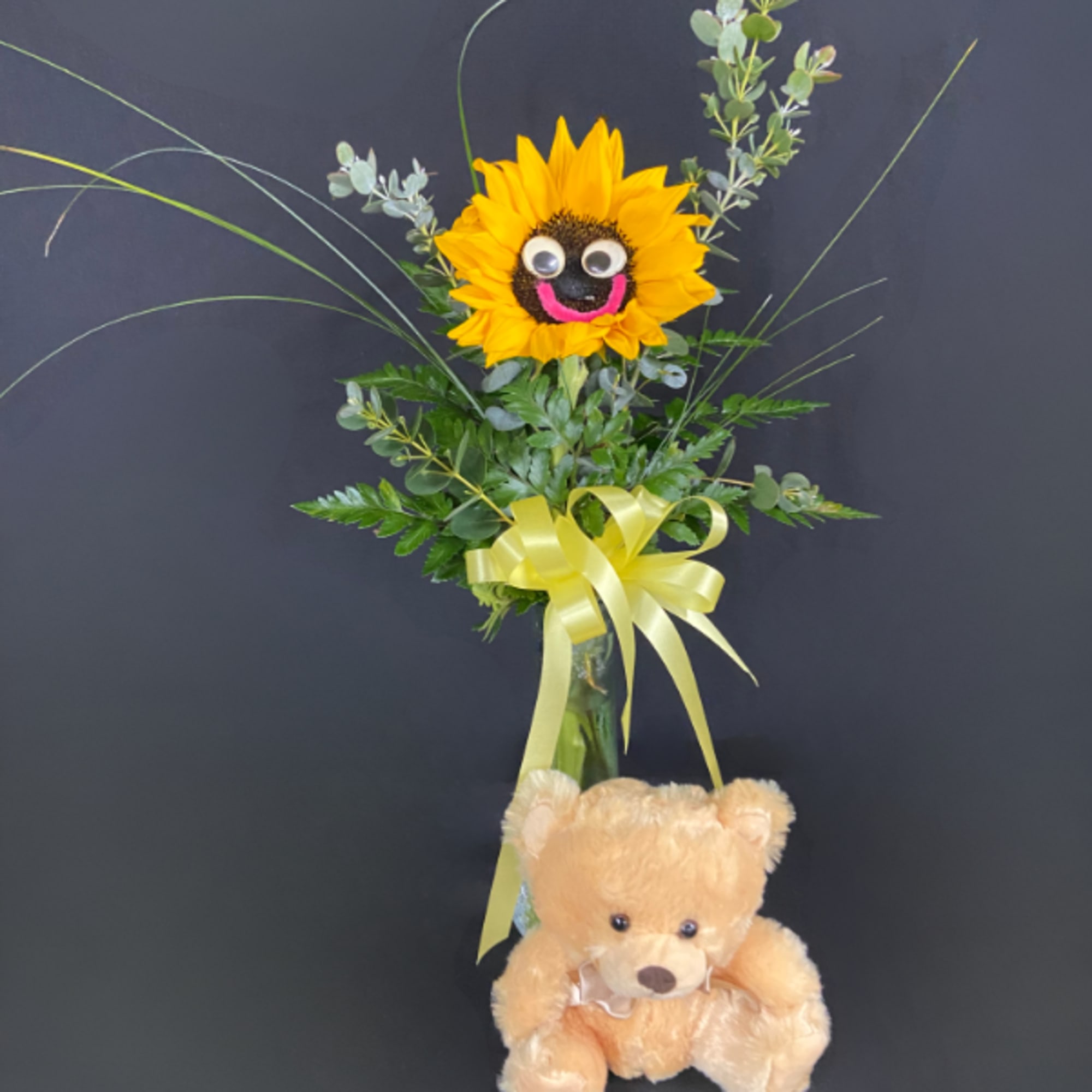 Sunflower arrangement with a teddy bear and yellow ribbon