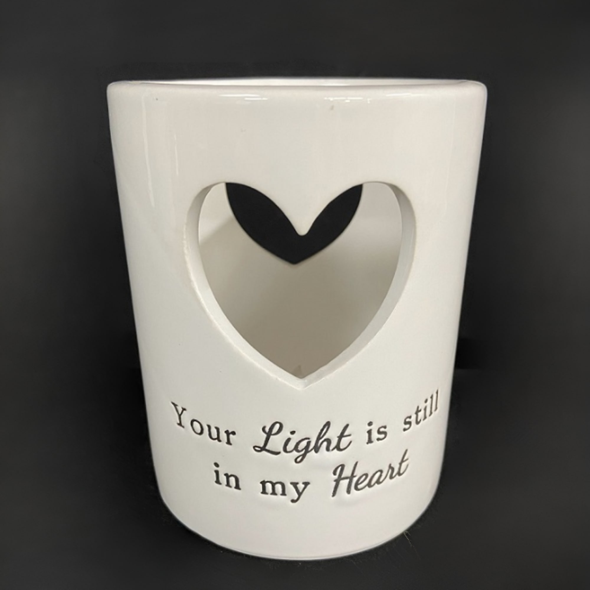 White ceramic memorial candle holder with a heart cutout and printed text