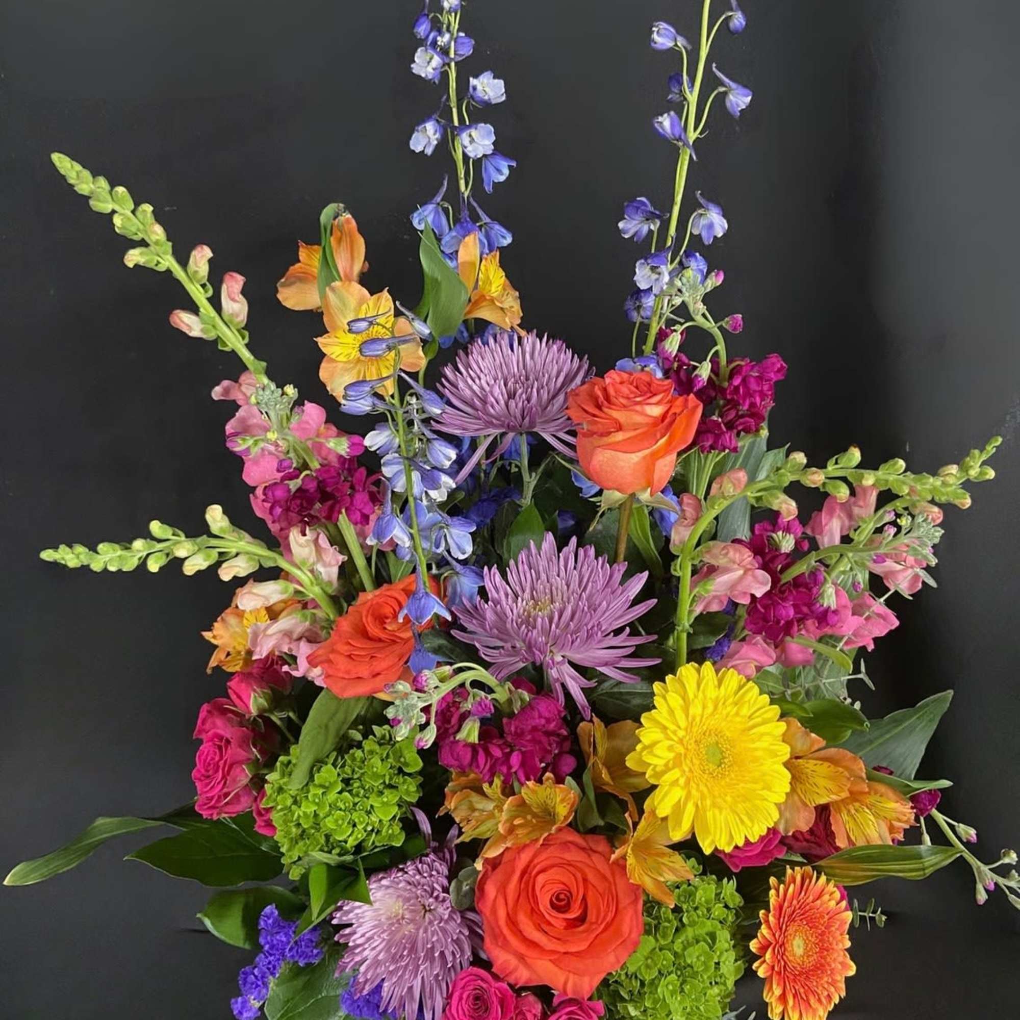 Send an arrangement as colorful and vibrant as them! With purple stock