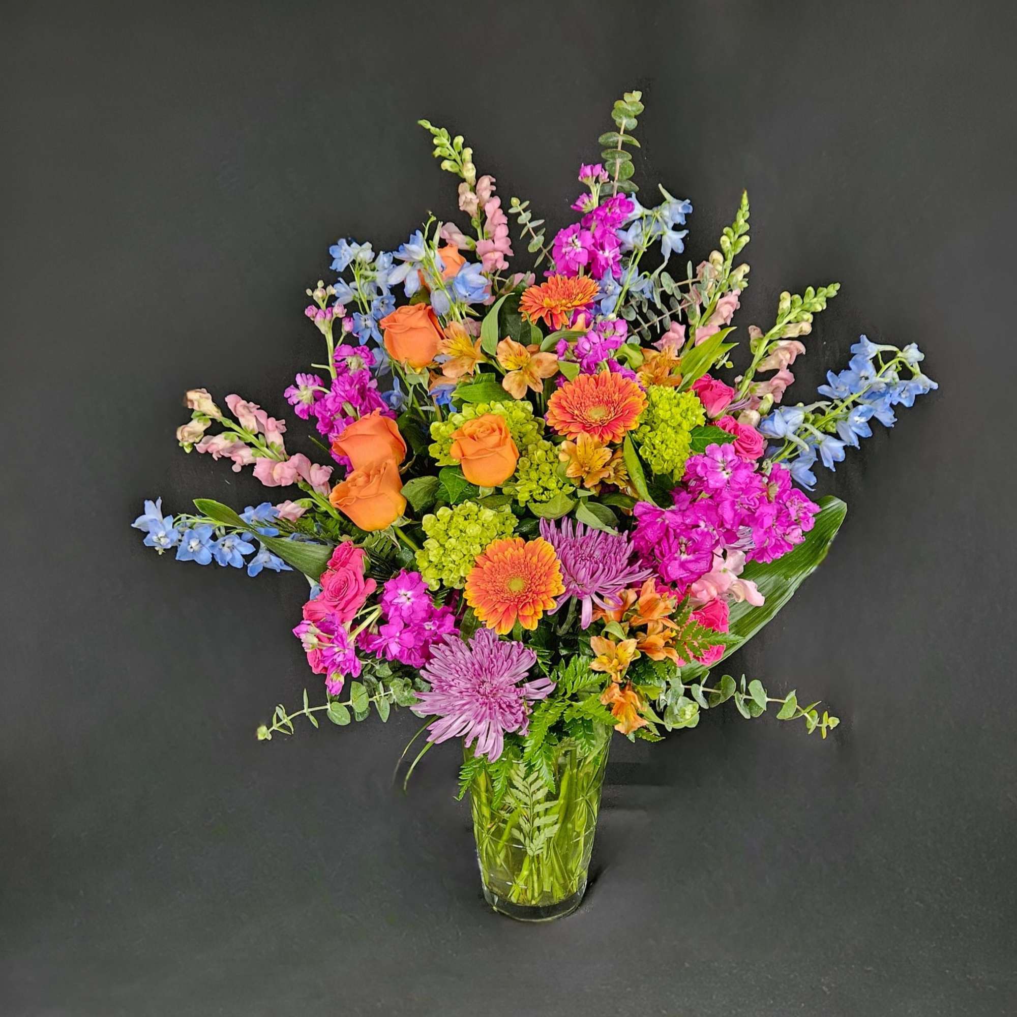 Send an arrangement as colorful and vibrant as them! With purple stock