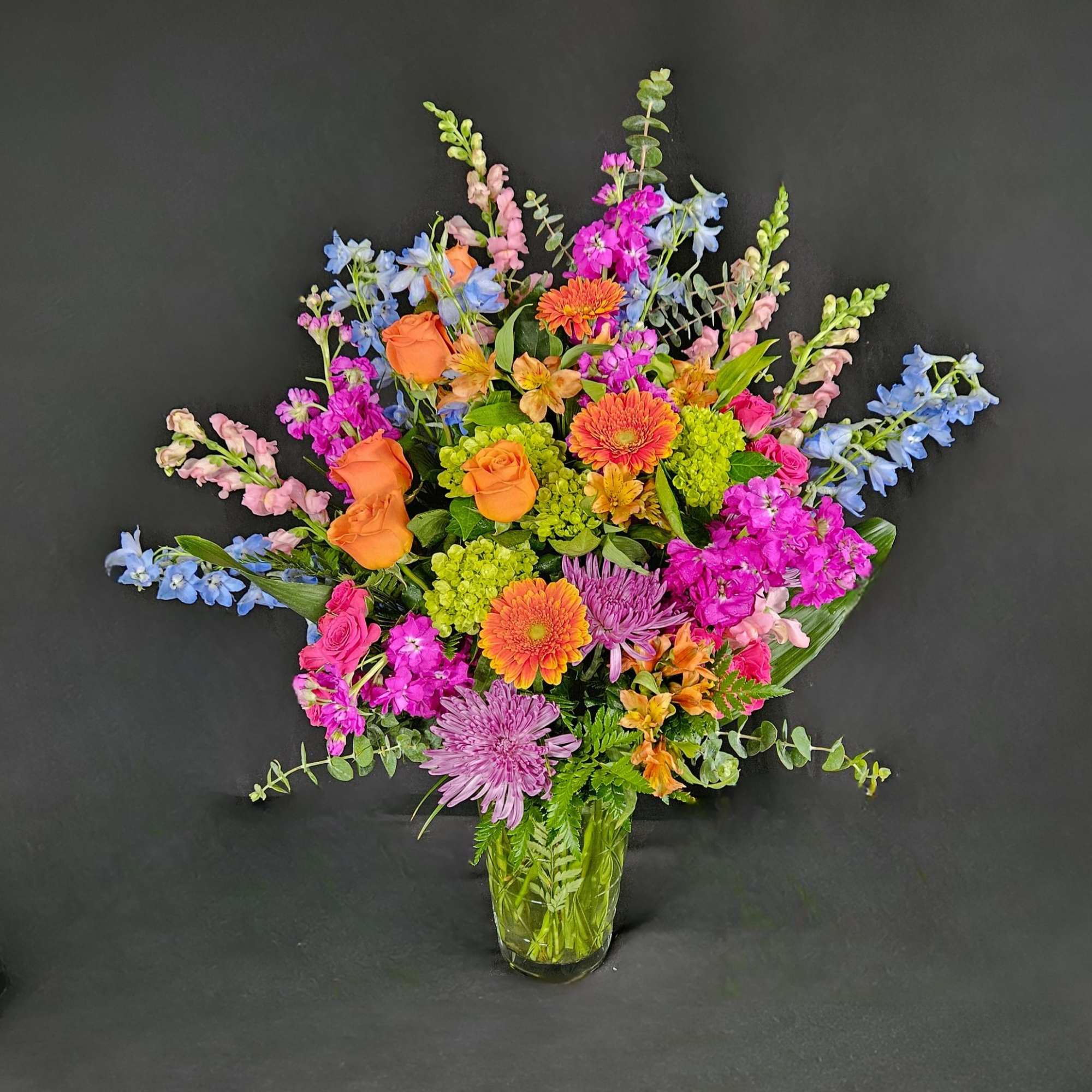 Send an arrangement as colorful and vibrant as them! With purple stock