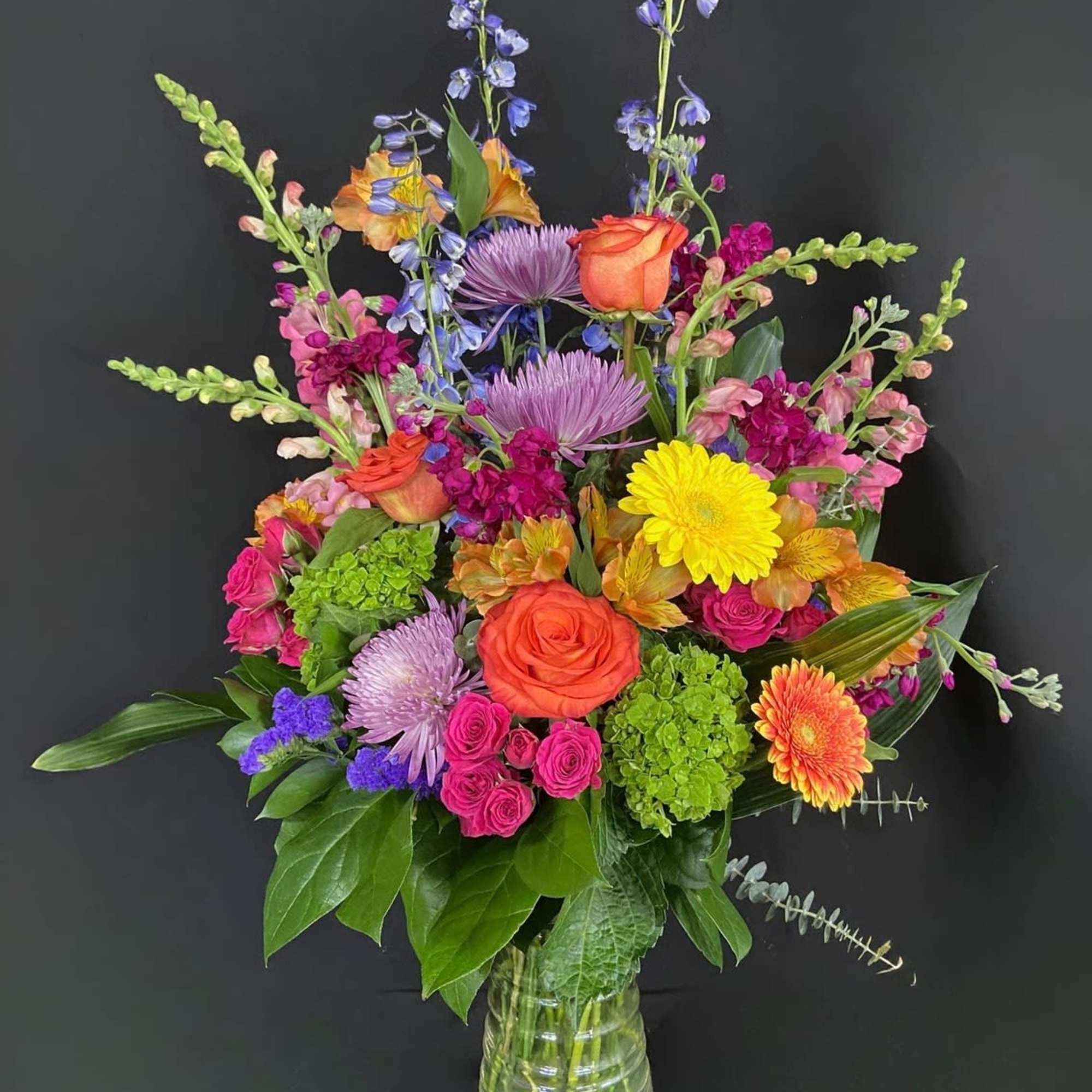 Send an arrangement as colorful and vibrant as them! With purple stock