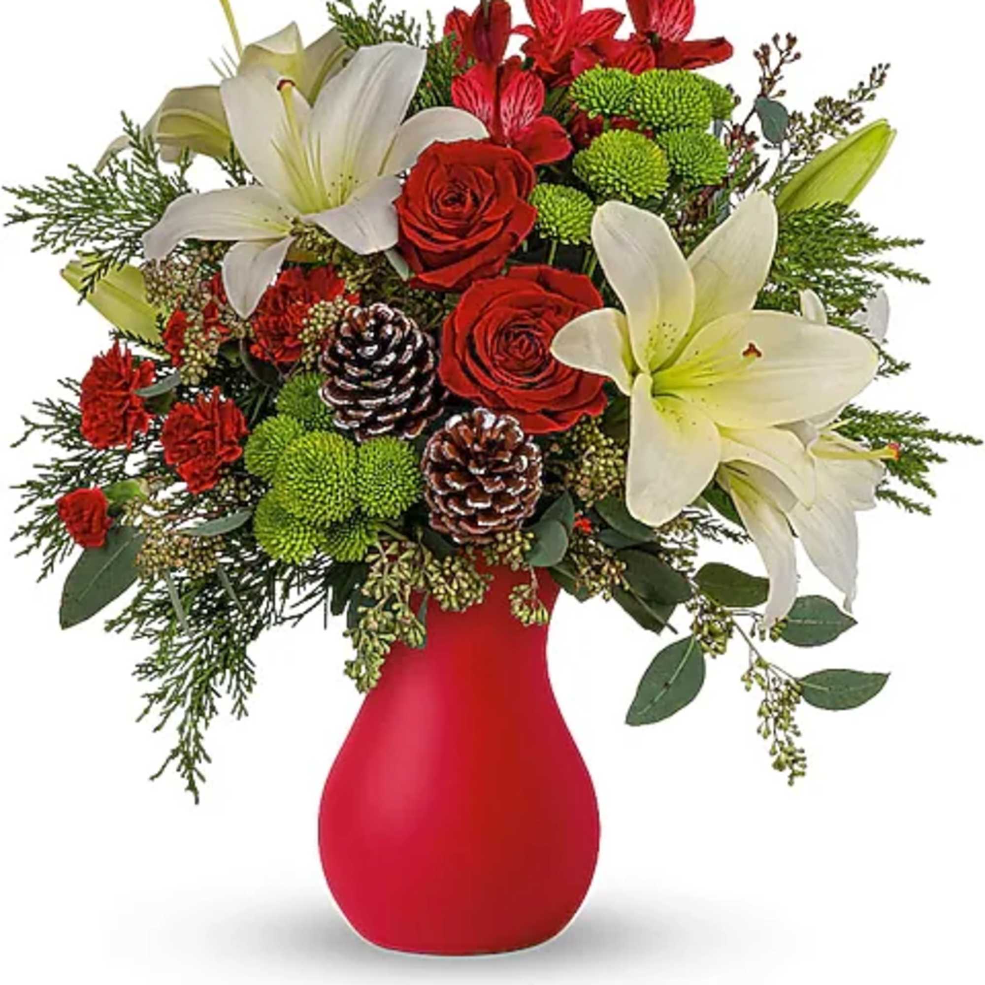 Red and white floral arrangement in a red vase with pinecones