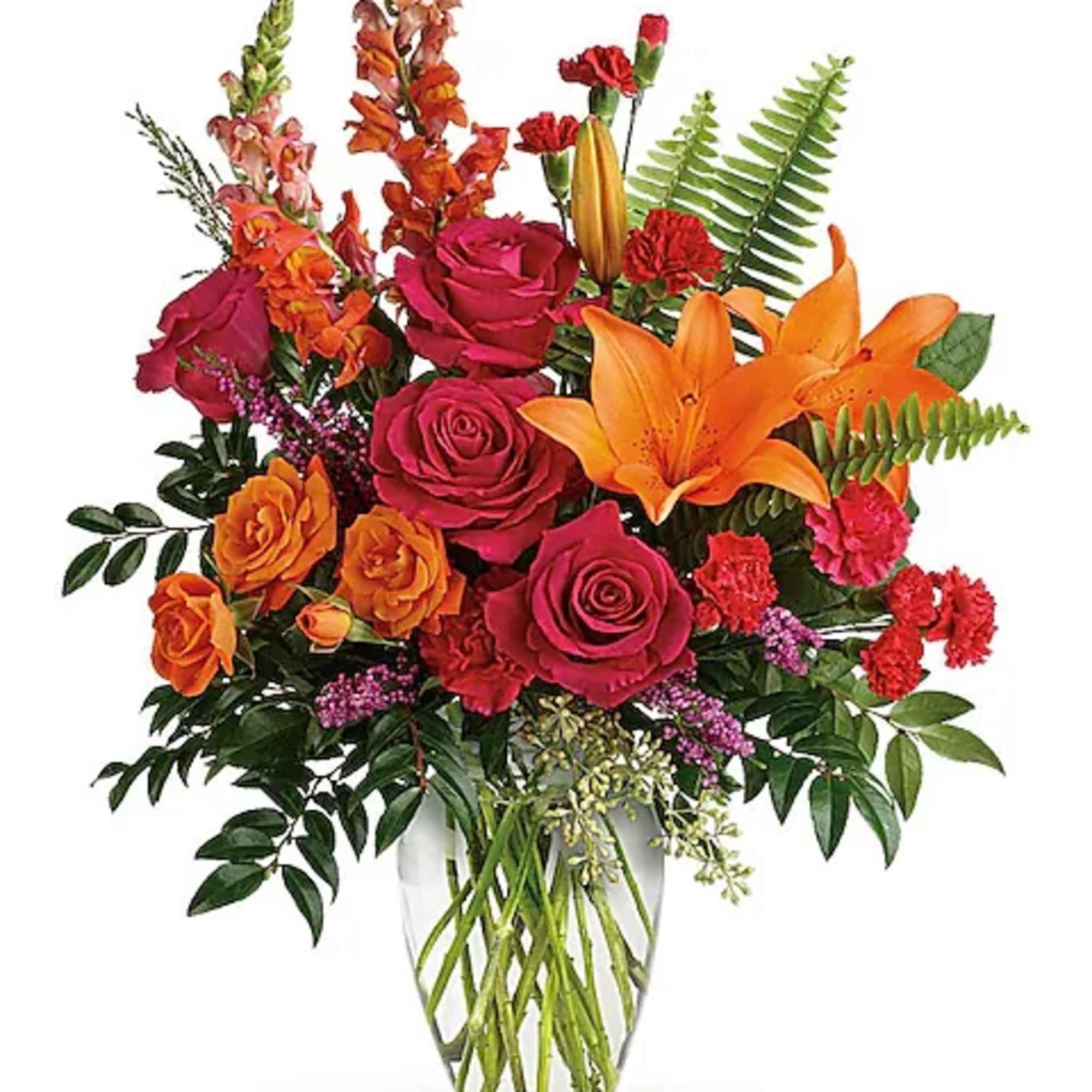 Mixed bouquet of roses and lilies in a clear glass vase