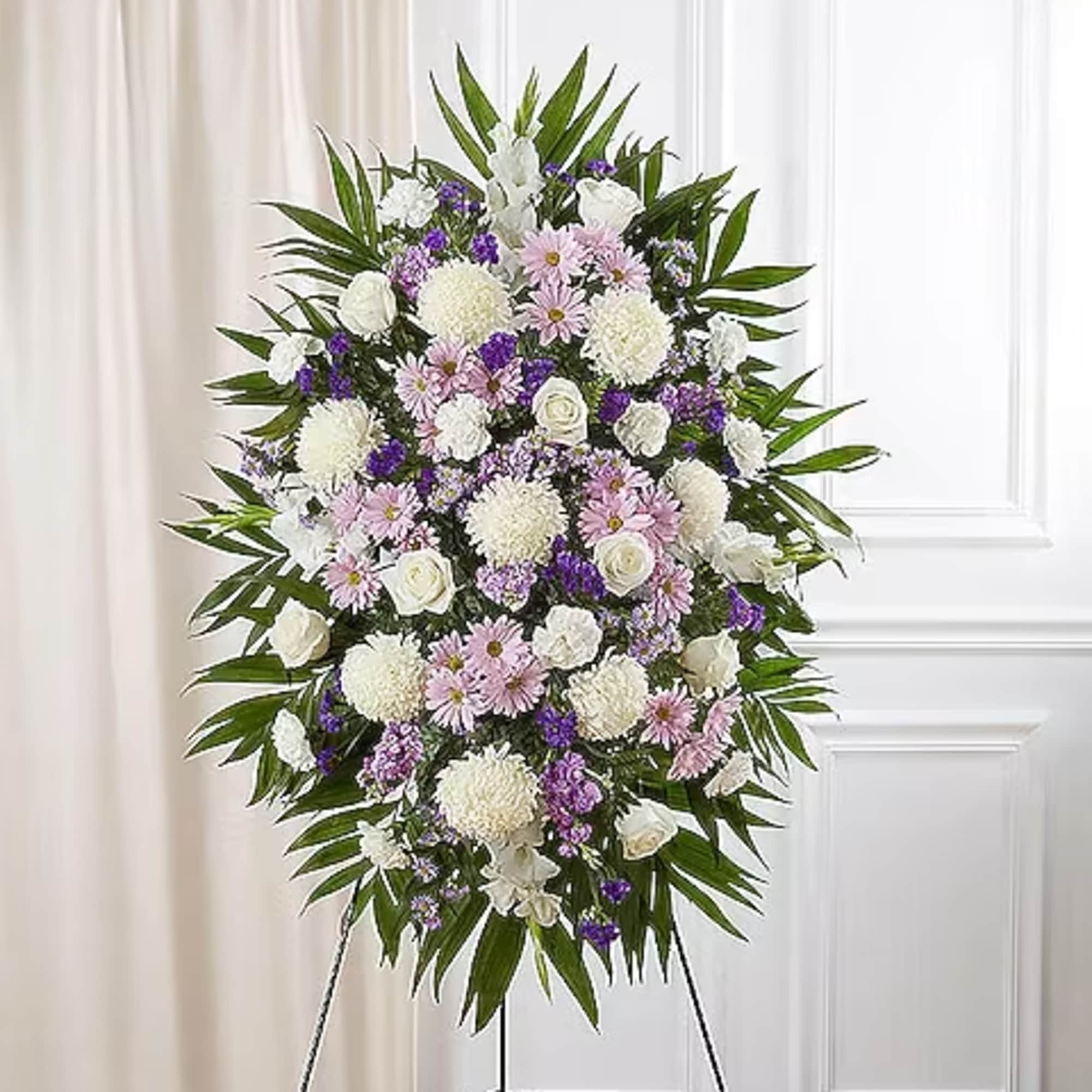 Standing floral spray of white, pink, and purple flowers on an easel