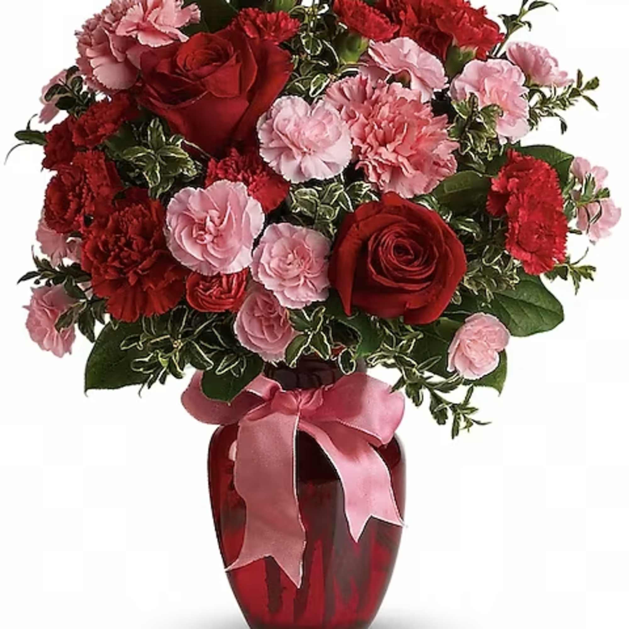 Red roses and pink carnations in a red glass vase with a pink ribbon