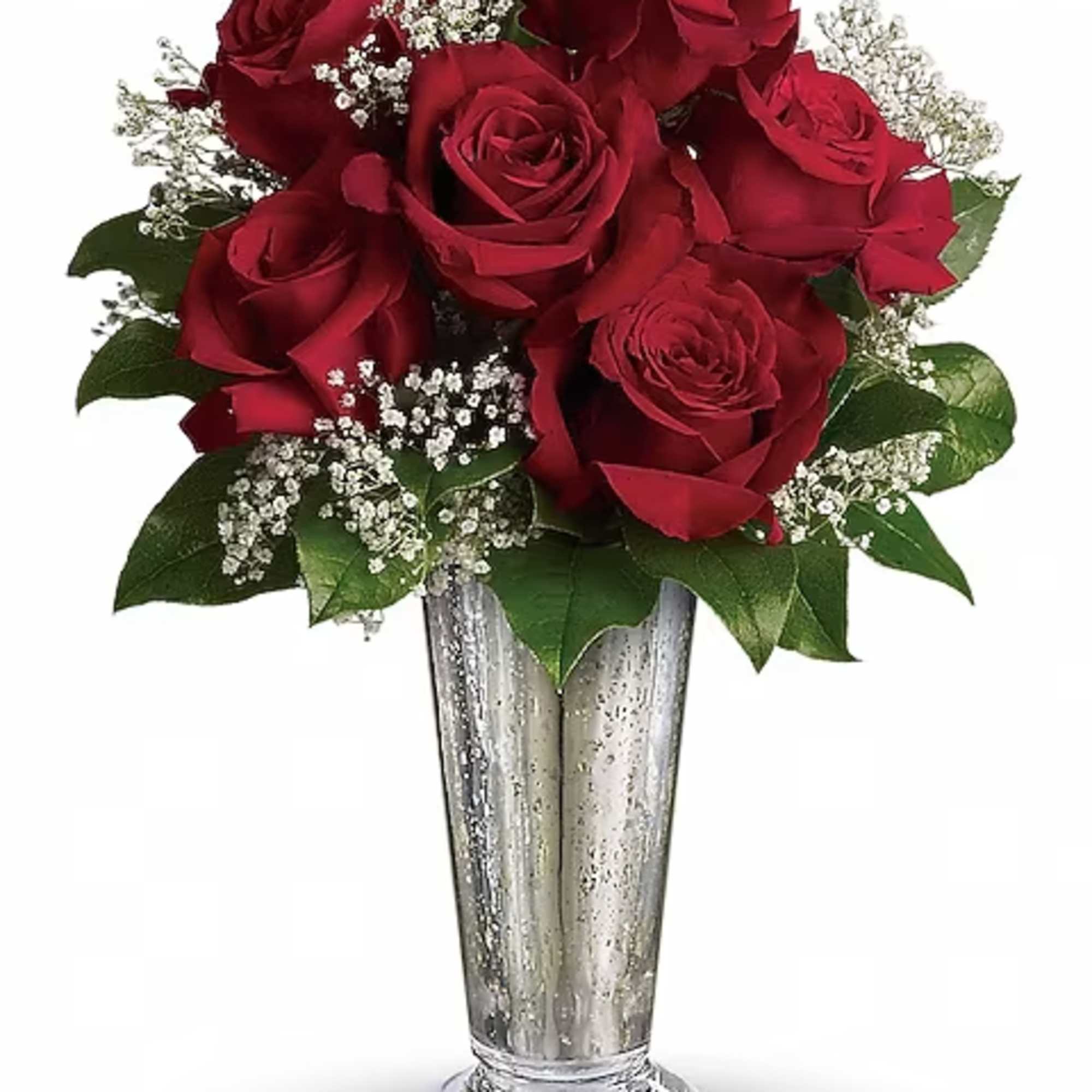Red roses arranged in a tall silver vase with white filler flowers