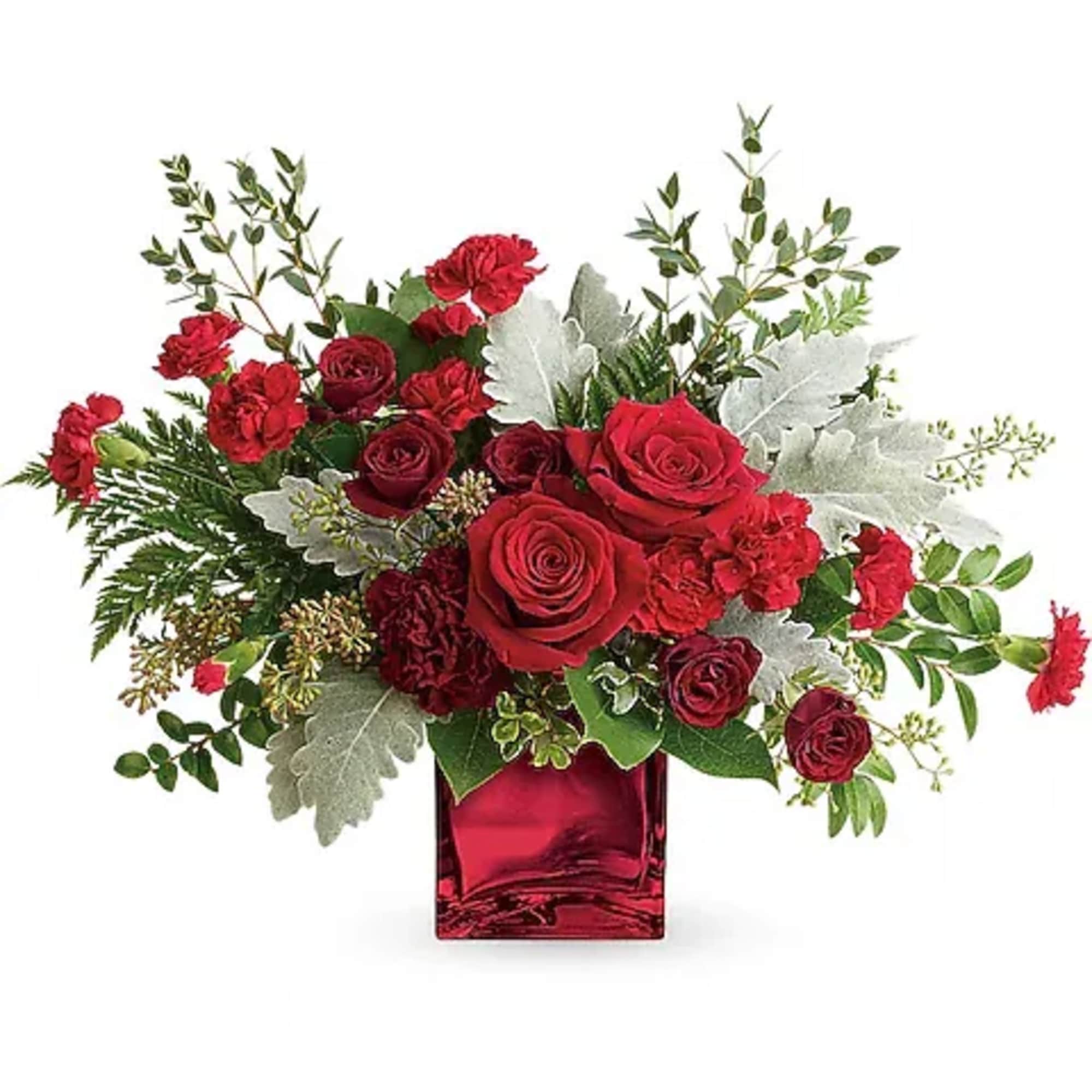Red roses and carnations arranged in a red glass vase