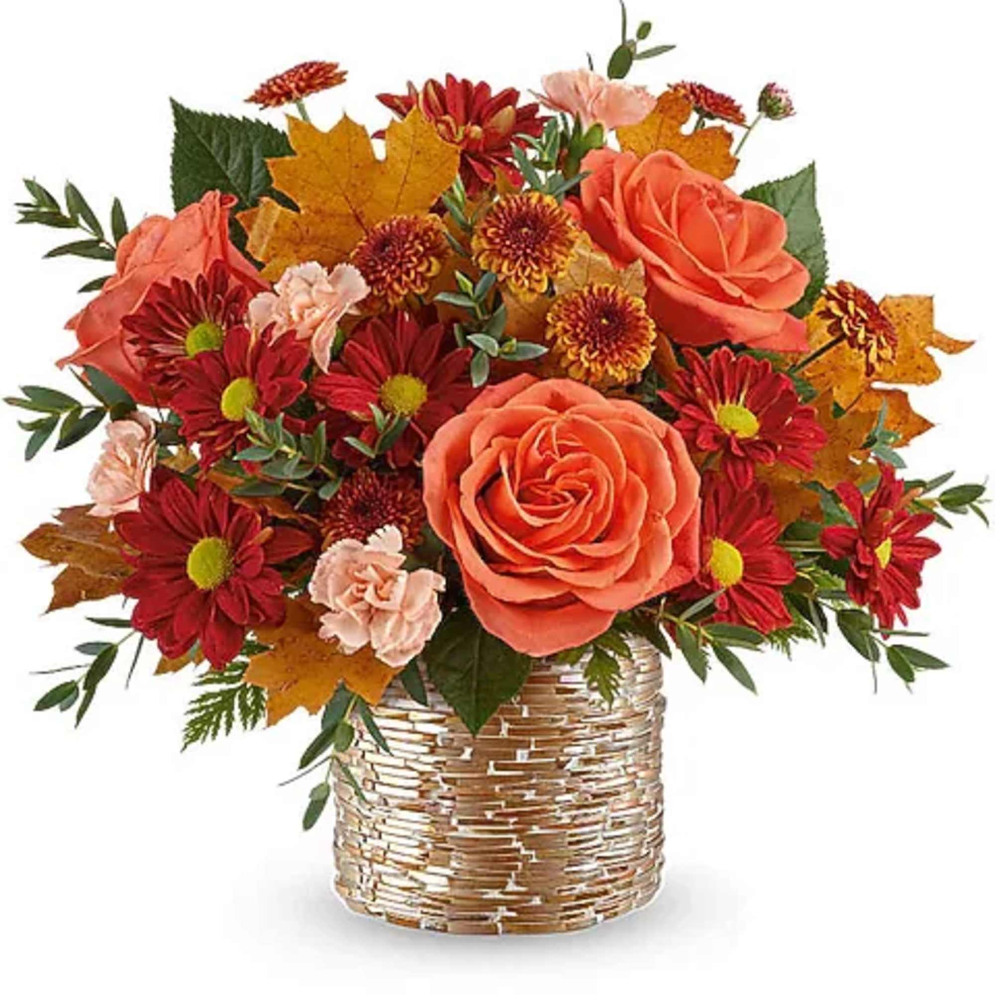 Autumn bouquet of orange roses and red daisies in a woven basket