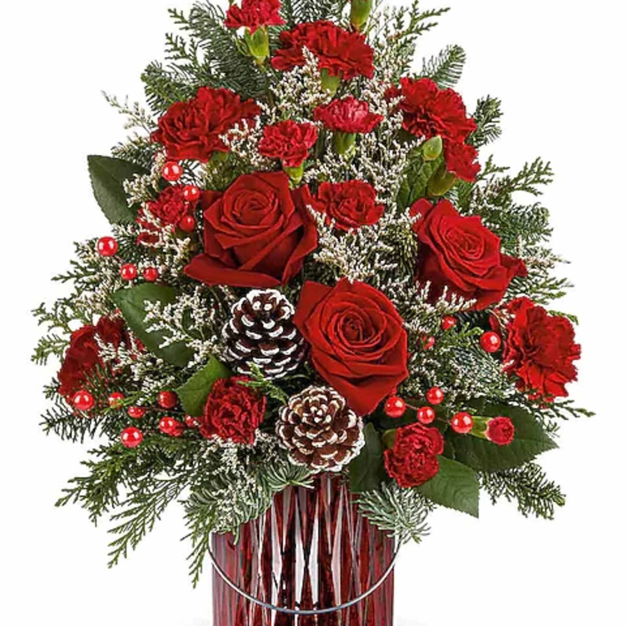 Red roses and carnations in a red glass vase with pinecones