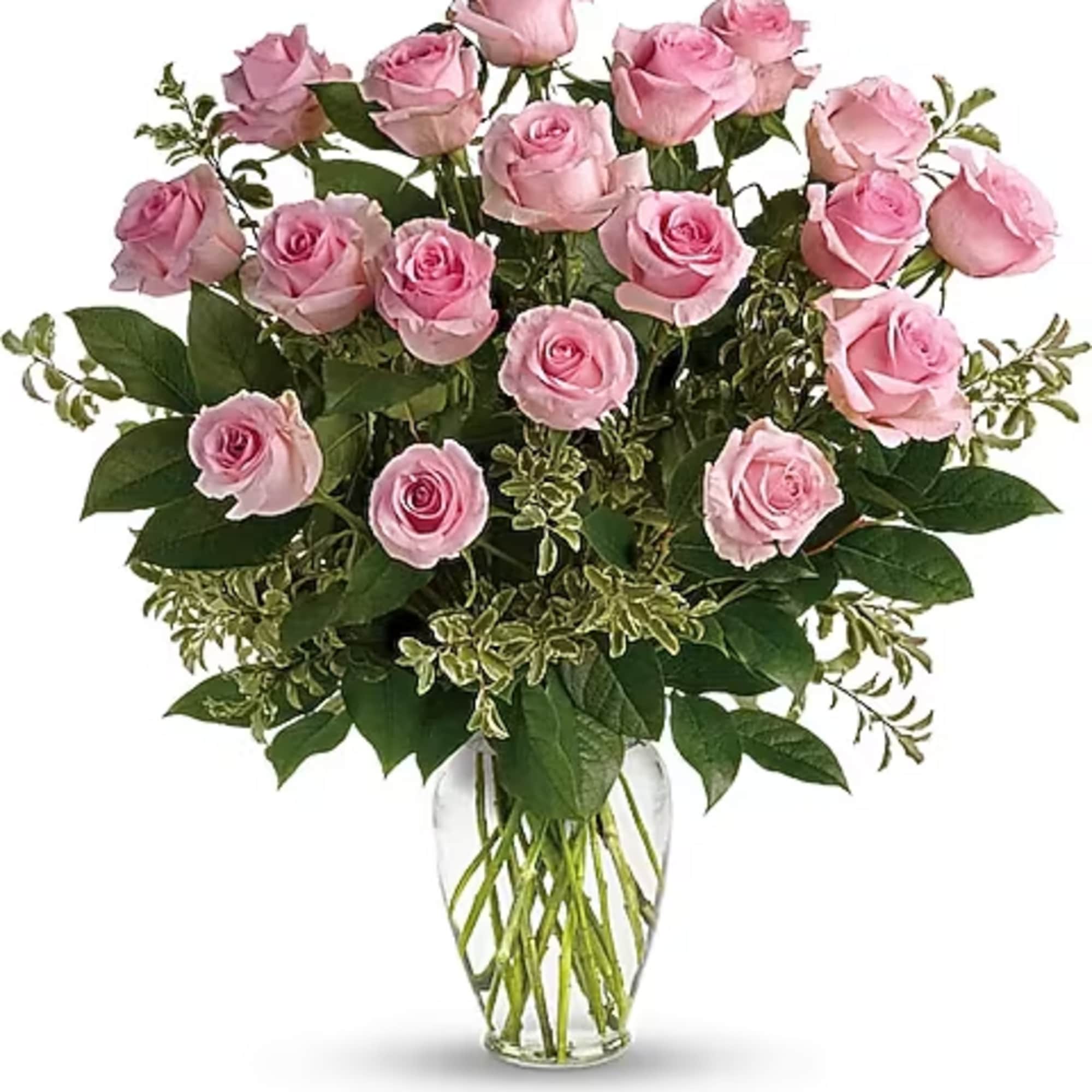 Pink roses arranged in a clear glass vase