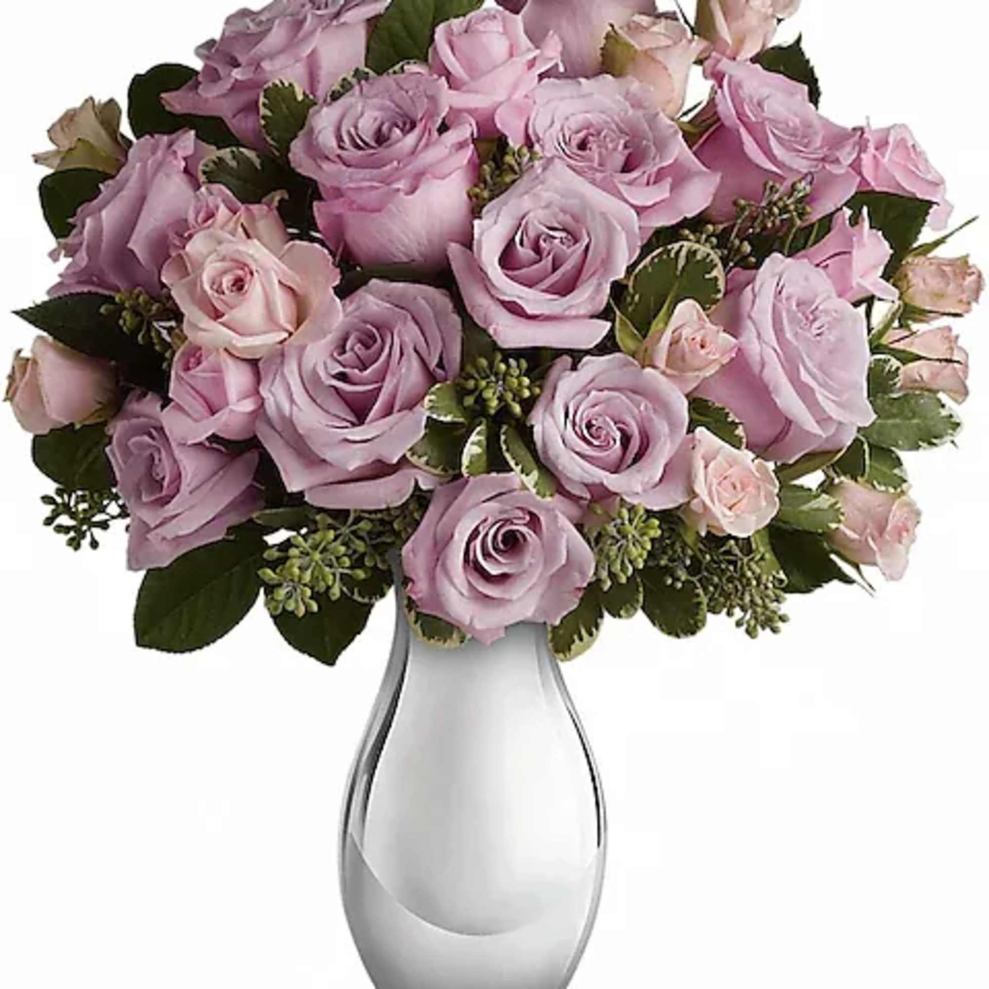 Lavender and pink roses arranged in a clear glass vase