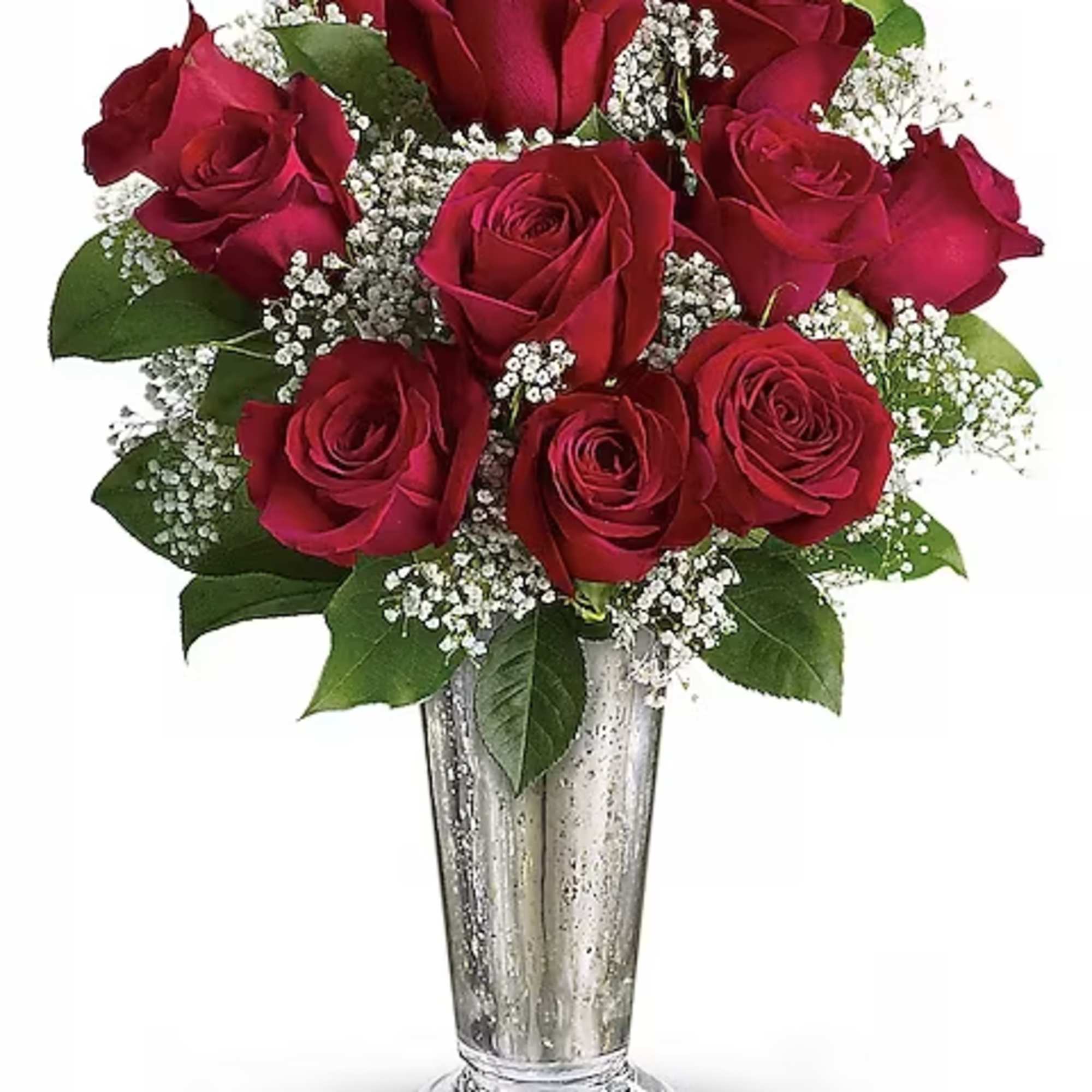 Red roses arranged in a clear glass vase with white filler flowers