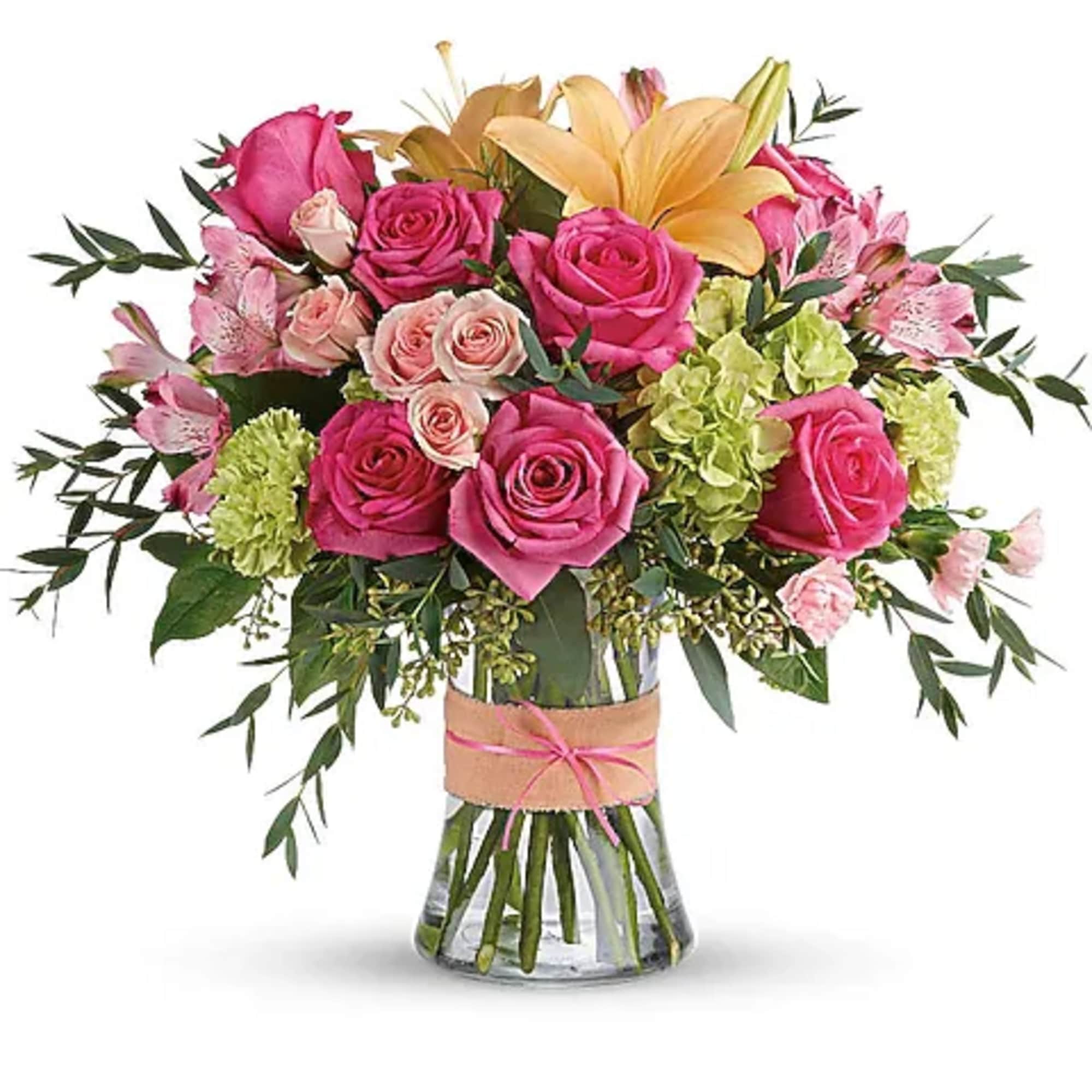 Pink and peach rose bouquet in a clear glass vase