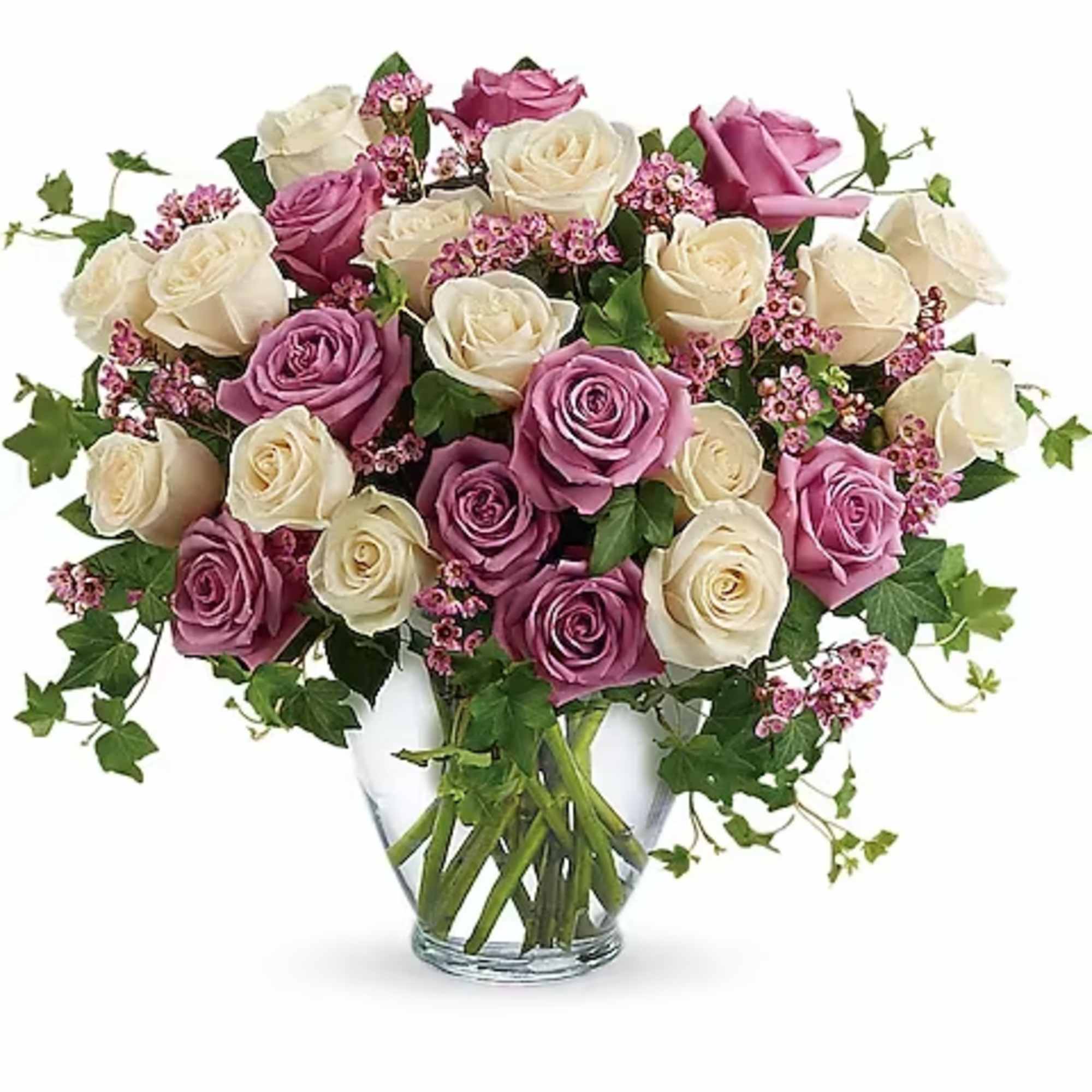 Bouquet of pink and cream roses in a clear glass vase