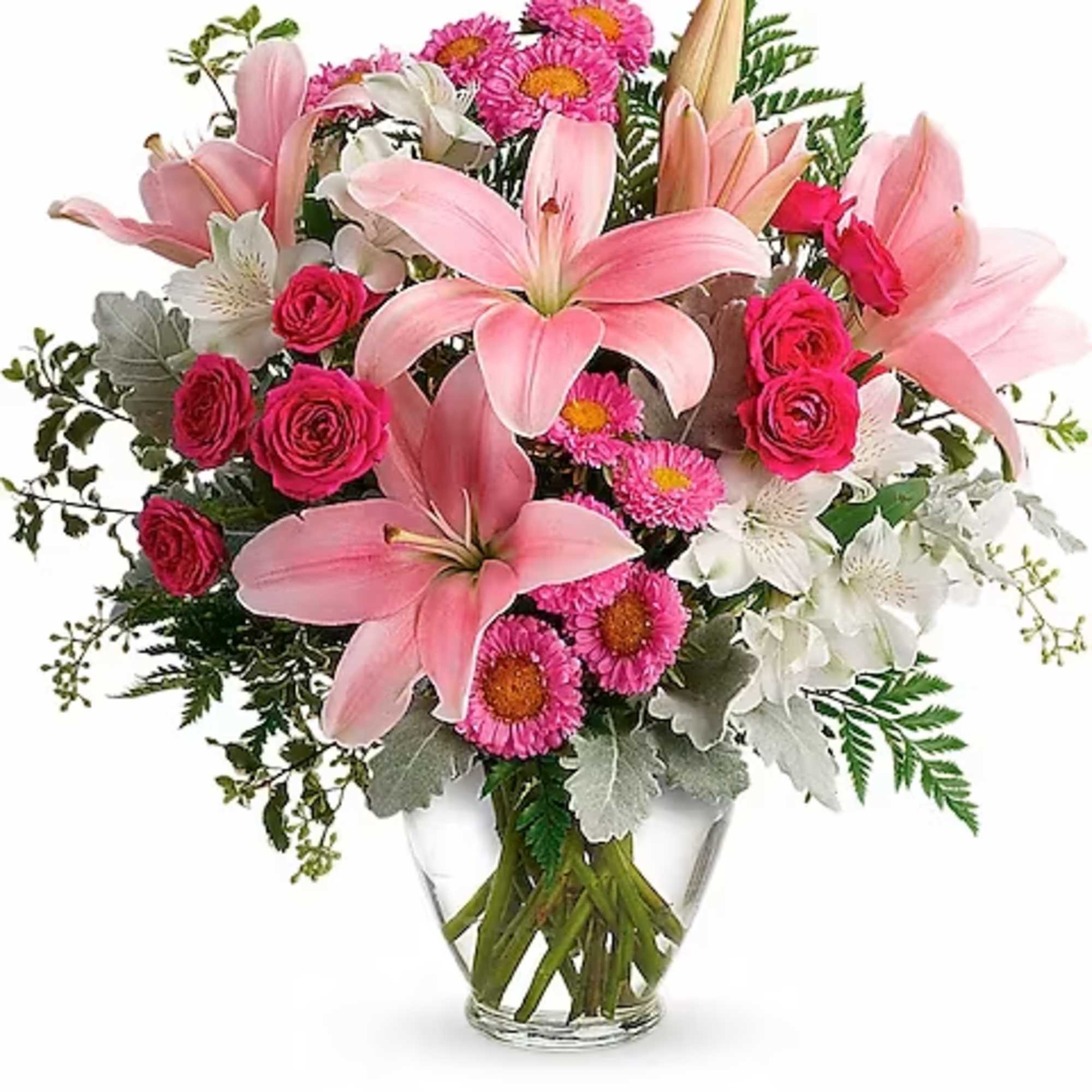 Pink lilies and roses arranged in a clear glass vase