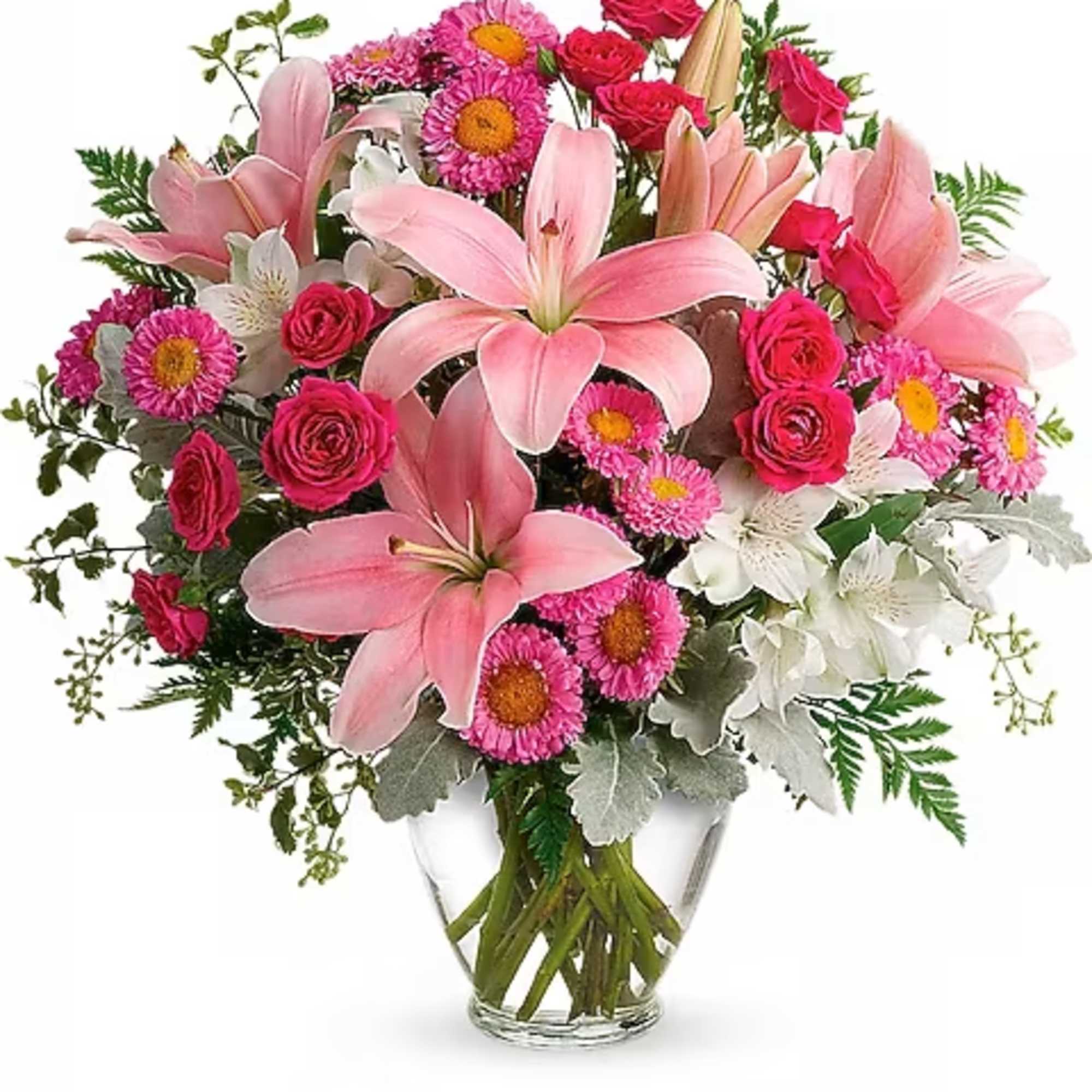 Pink lilies and roses with daisies in a clear glass vase