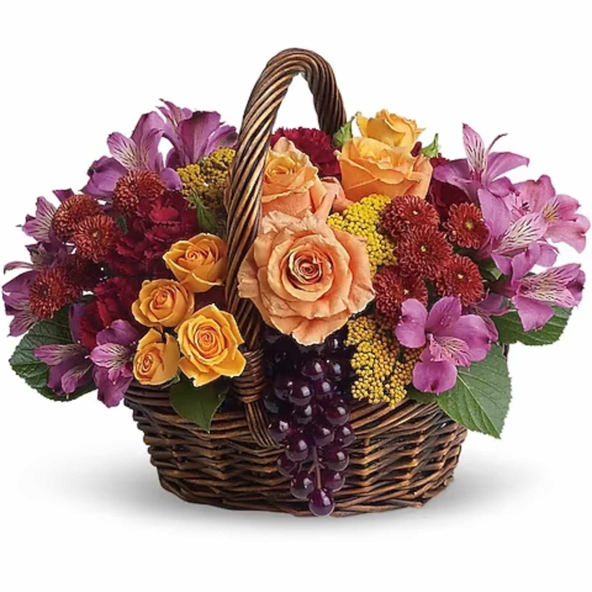 Basket arrangement of roses, alstroemeria, and mums in purple and peach tones