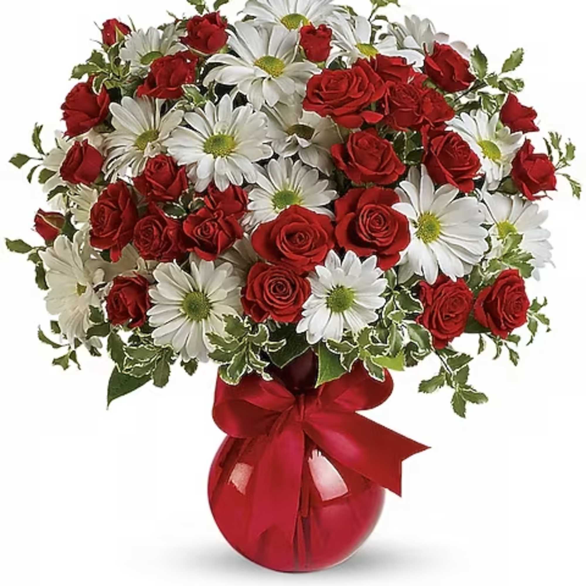 Bouquet of red roses and white daisies in a red glass vase